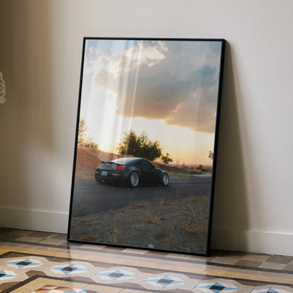 Nissan 350z sports car wall art poster with sunset sky and desert landscape in matte black frame.