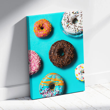Canvas wall art featuring colorful sprinkled donuts on bright blue background for kitchen decor.