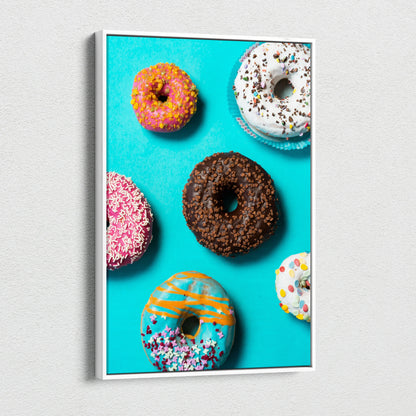 Colorful donut assortment on vibrant blue canvas wall art for kitchen decor.