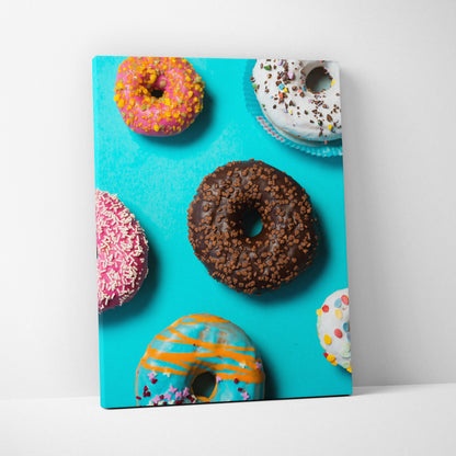Colorful donut-themed canvas wall art with bright sprinkles on a vibrant blue background.