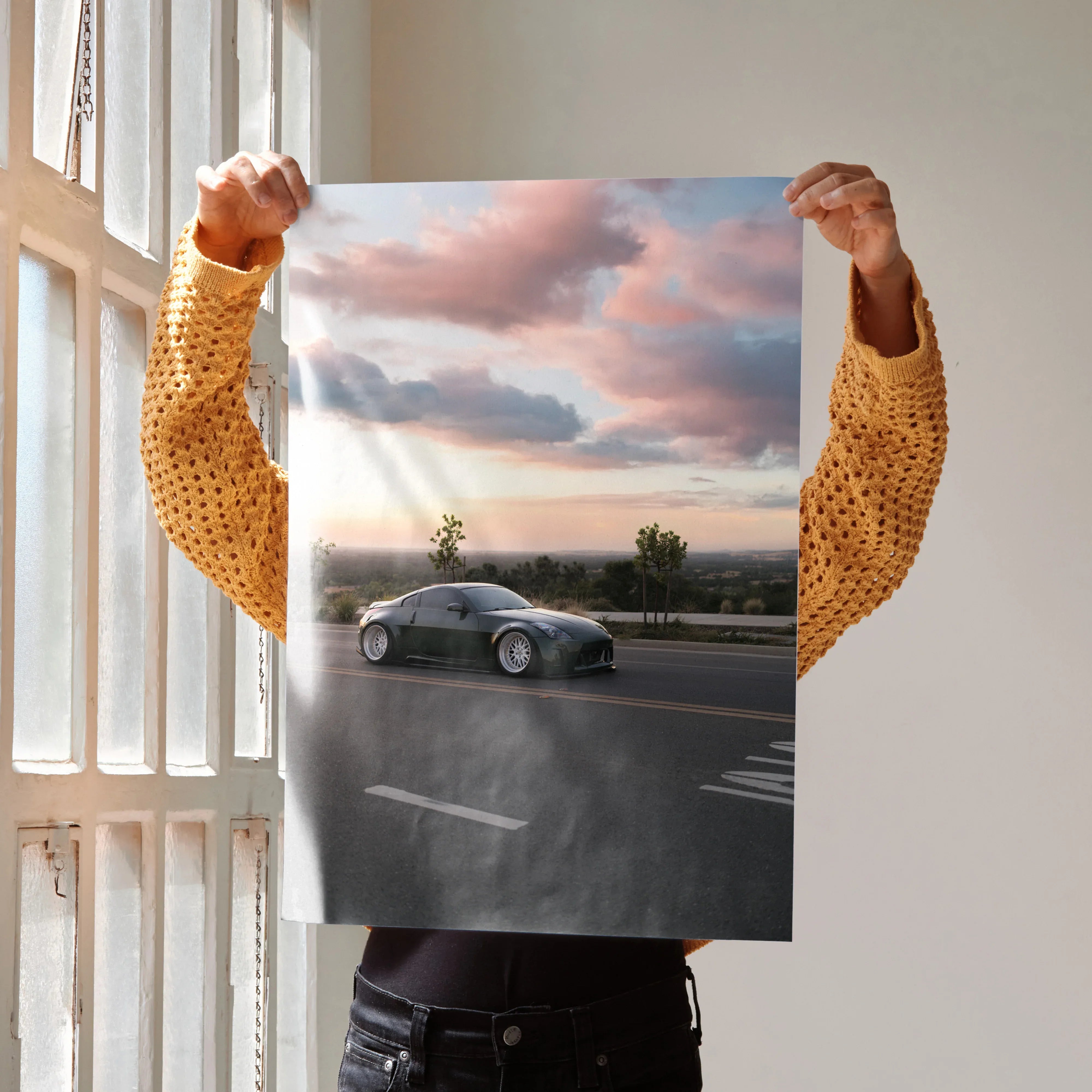 Nissan 350Z sports car driving on road at sunset poster wall art with vibrant sky colors.