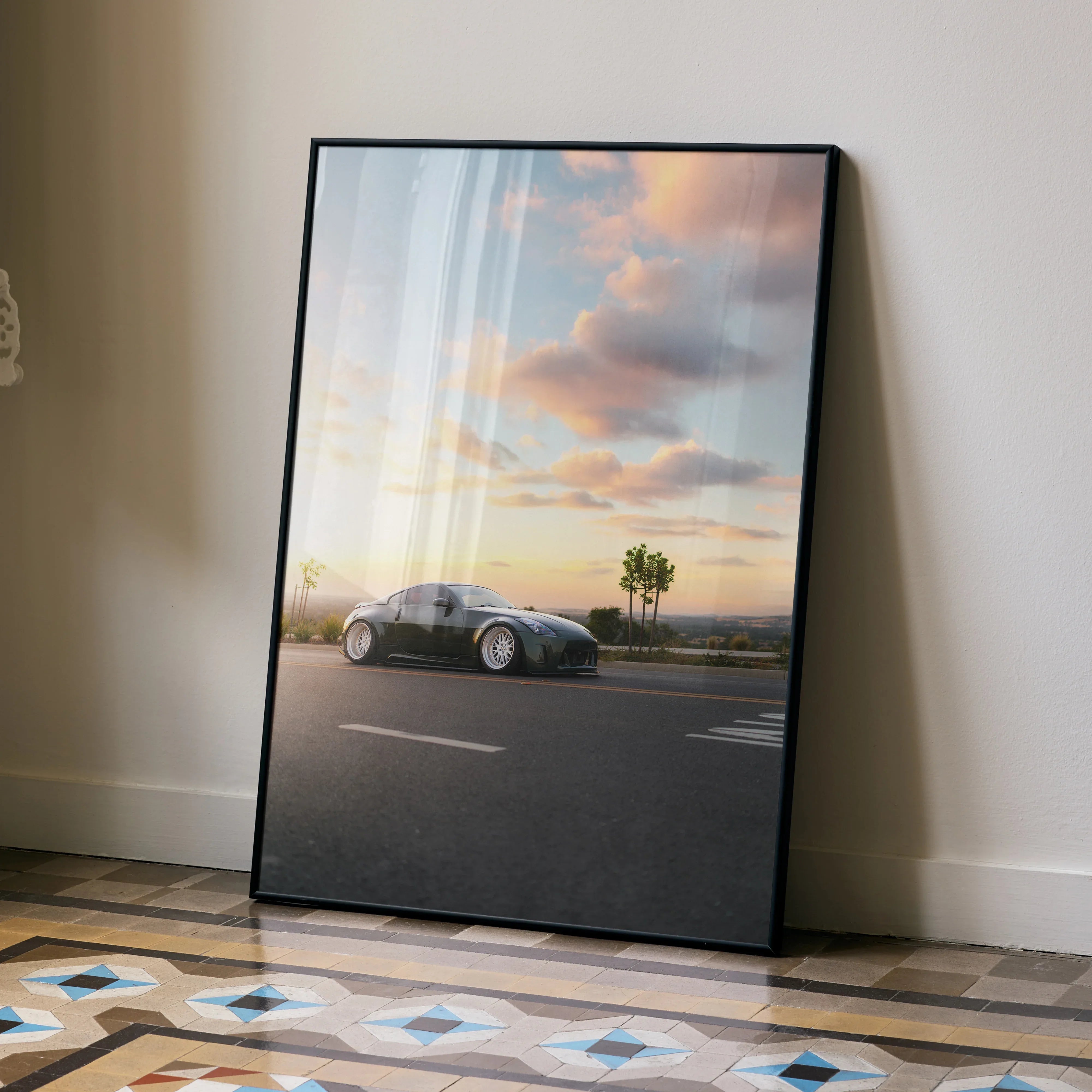 Nissan 350z high resolution car poster with sunset sky, framed wall art leaning on beige wall.