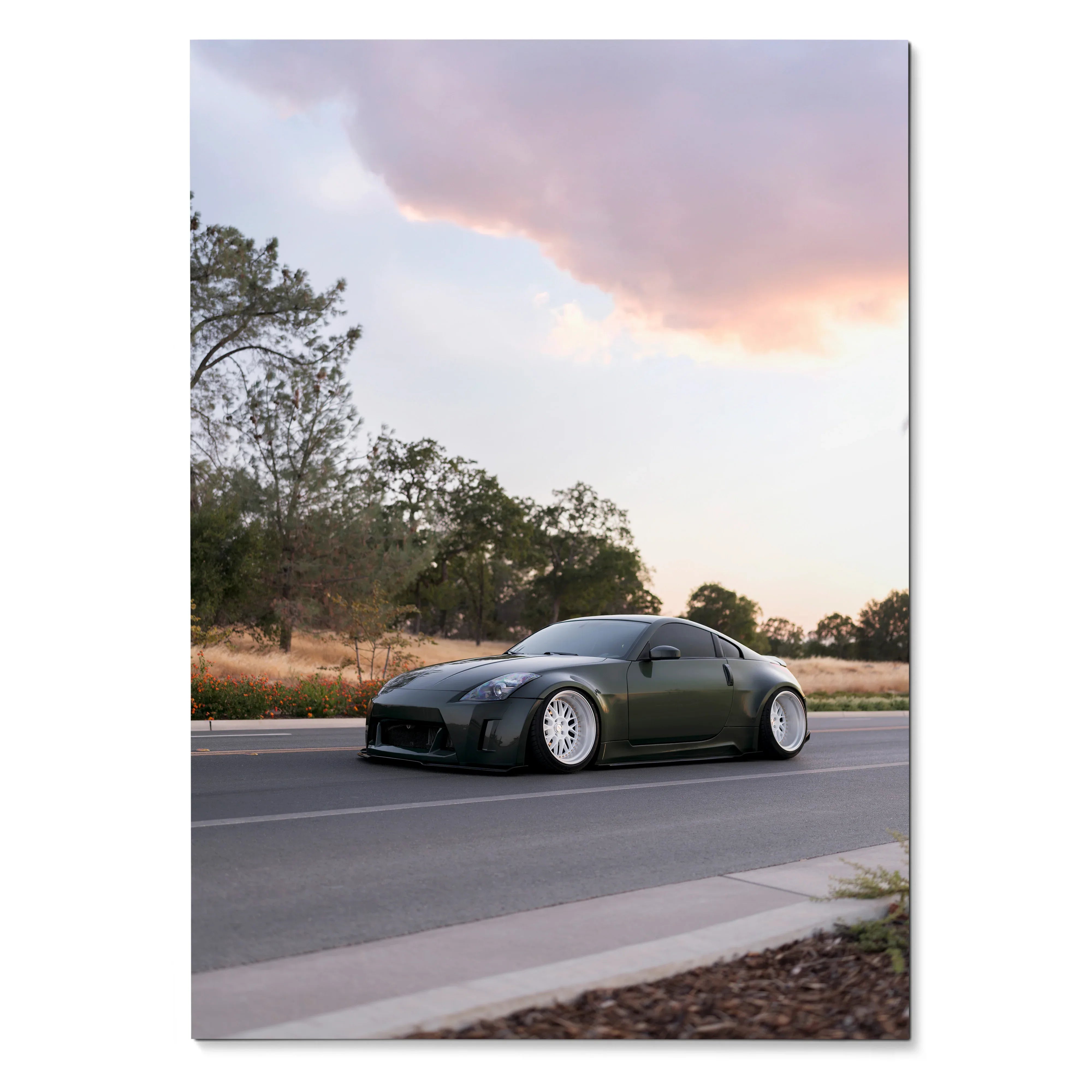 Nissan 350z sports car on road at sunset poster wall art with scenic background.