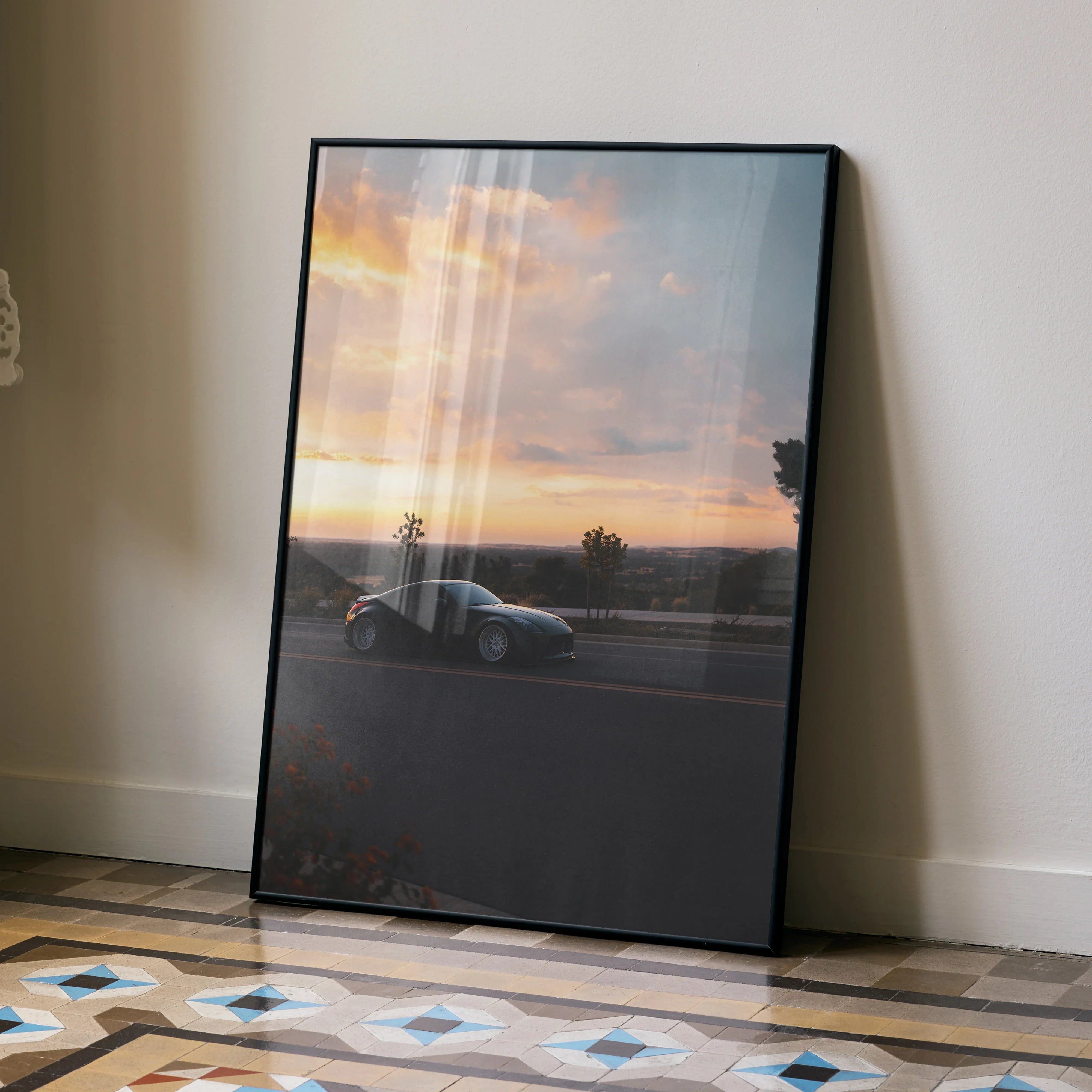 Nissan 350z parked on road at sunset in sleek Poster wall art with black frame.