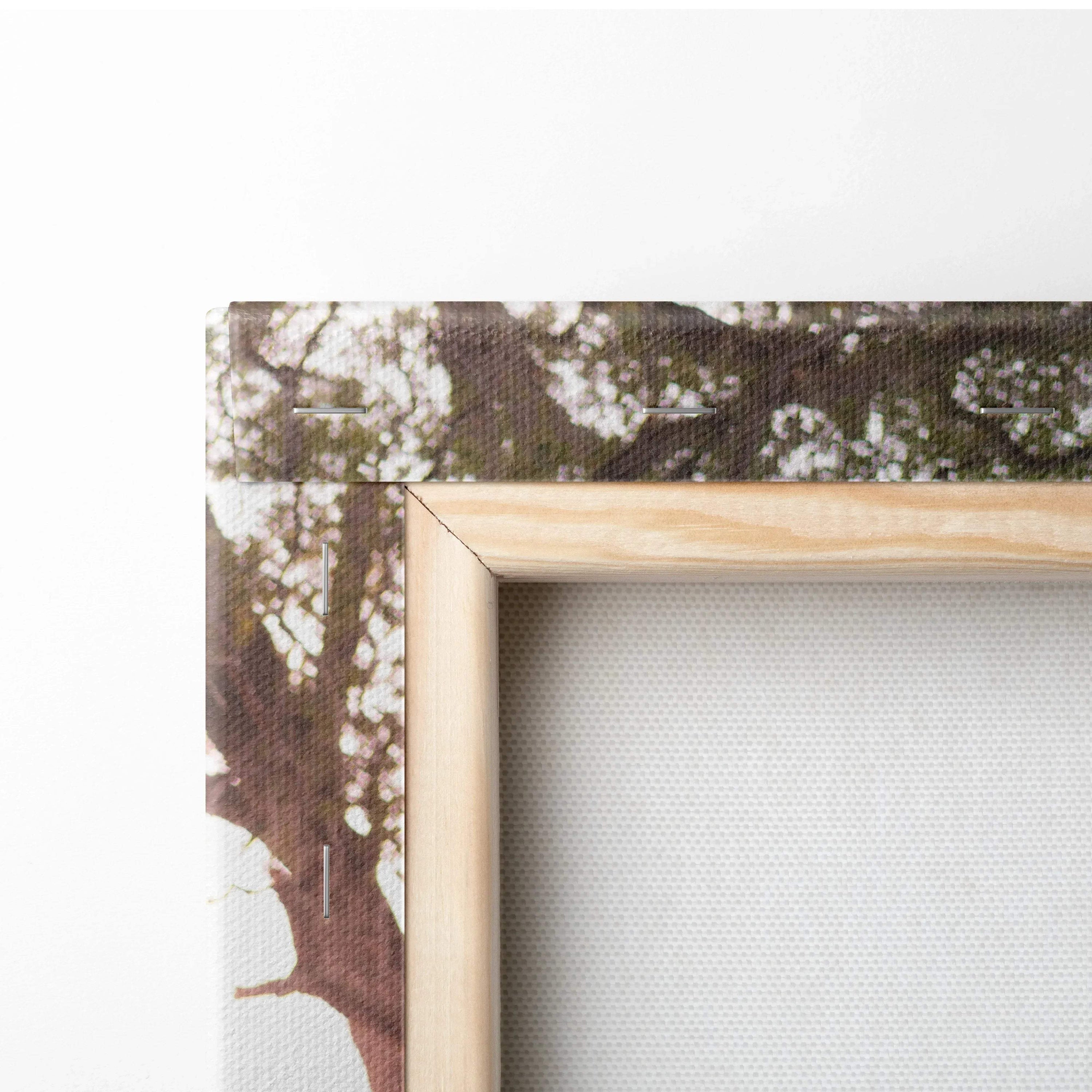 Close-up of natural wood frame and textured canvas edge with Yamaha R6 motorcycle art print, vertical wall art canvas.