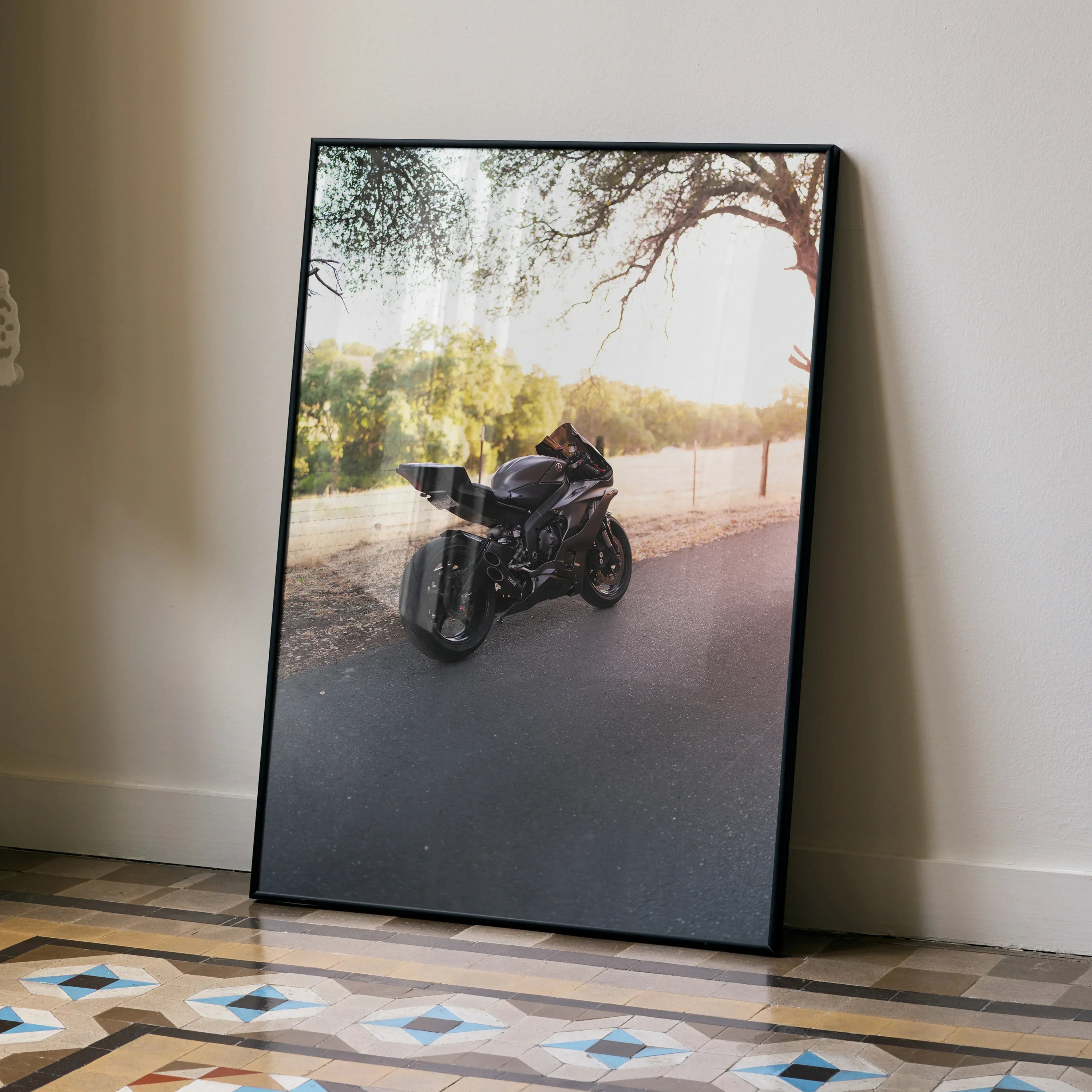 Yamaha R6 motorcycle poster leaning against wall with scenic outdoor road background wall art.
