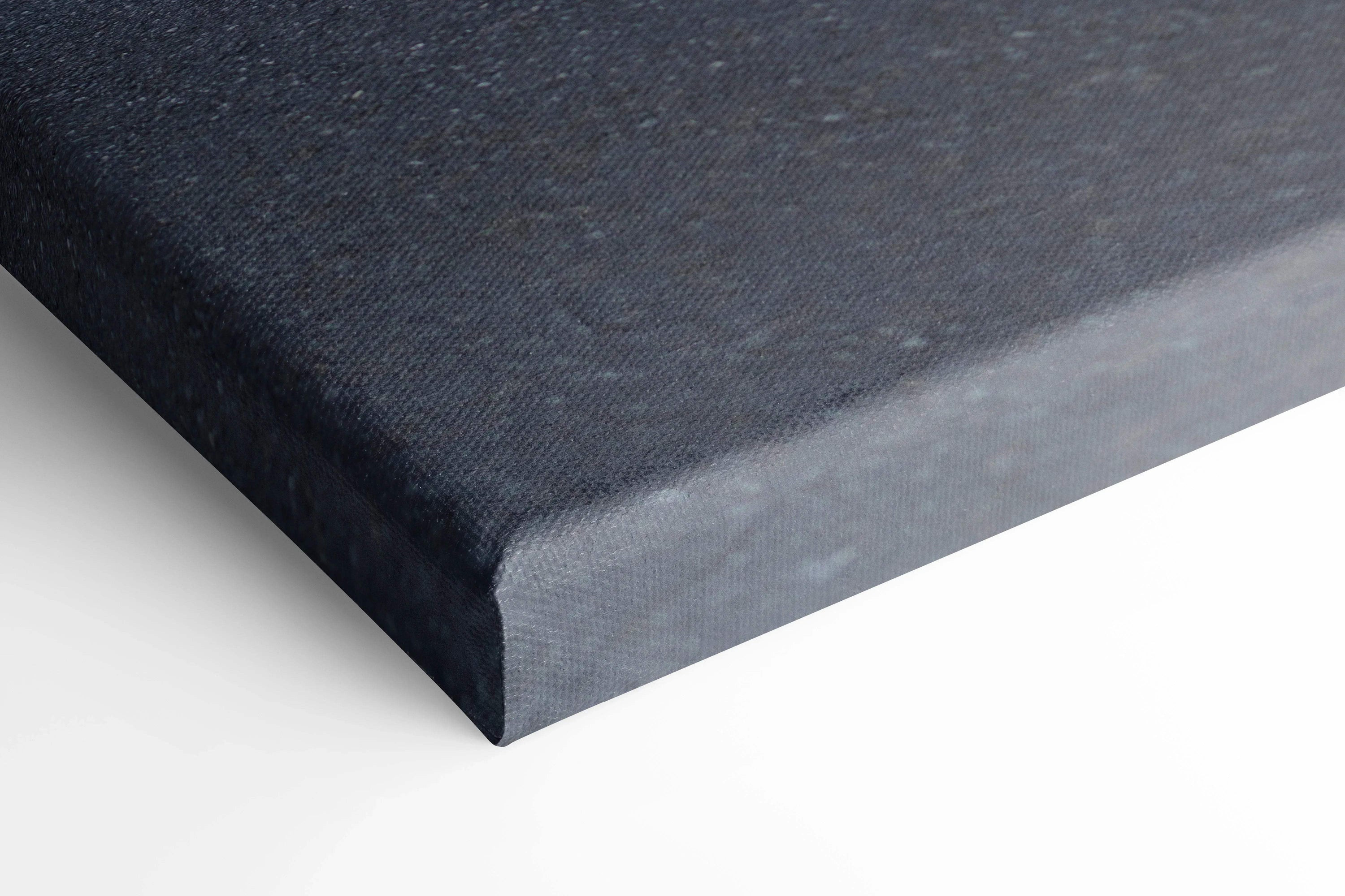 Close-up of black canvas edge with tight corner wrap, showcasing premium wall art texture.