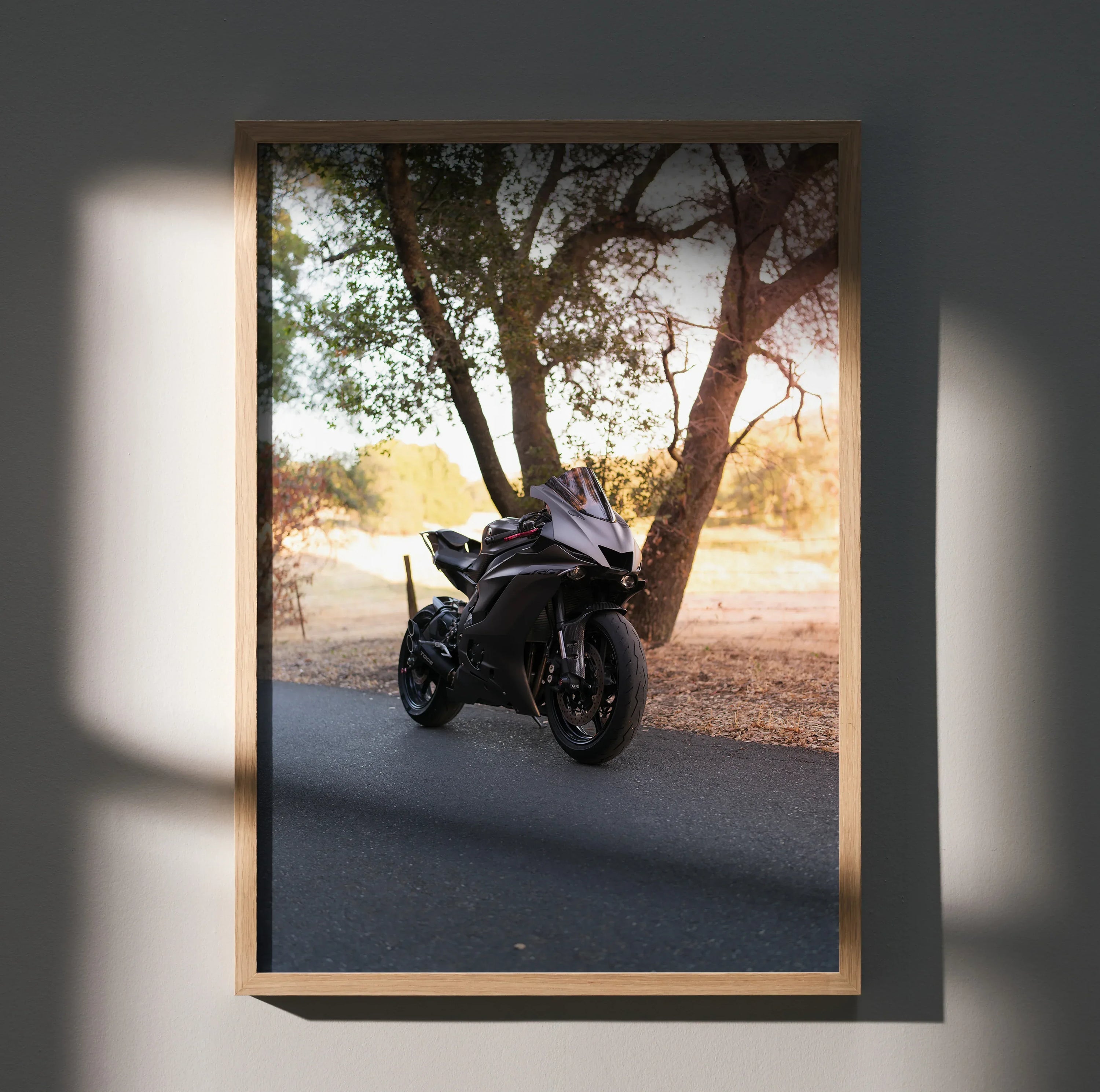 Yamaha R6 motorcycle poster wall art with black bike under a tree in warm light.