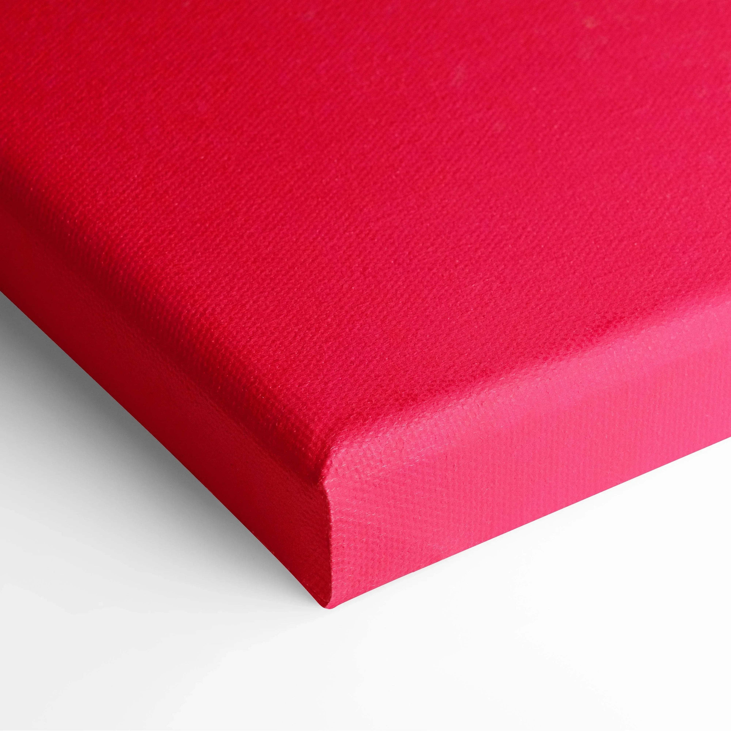 Close-up of vibrant red stretched canvas corner with smooth, textured fabric for wall art decor.