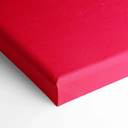 Close-up of vibrant red stretched canvas corner with smooth, textured fabric for wall art decor.