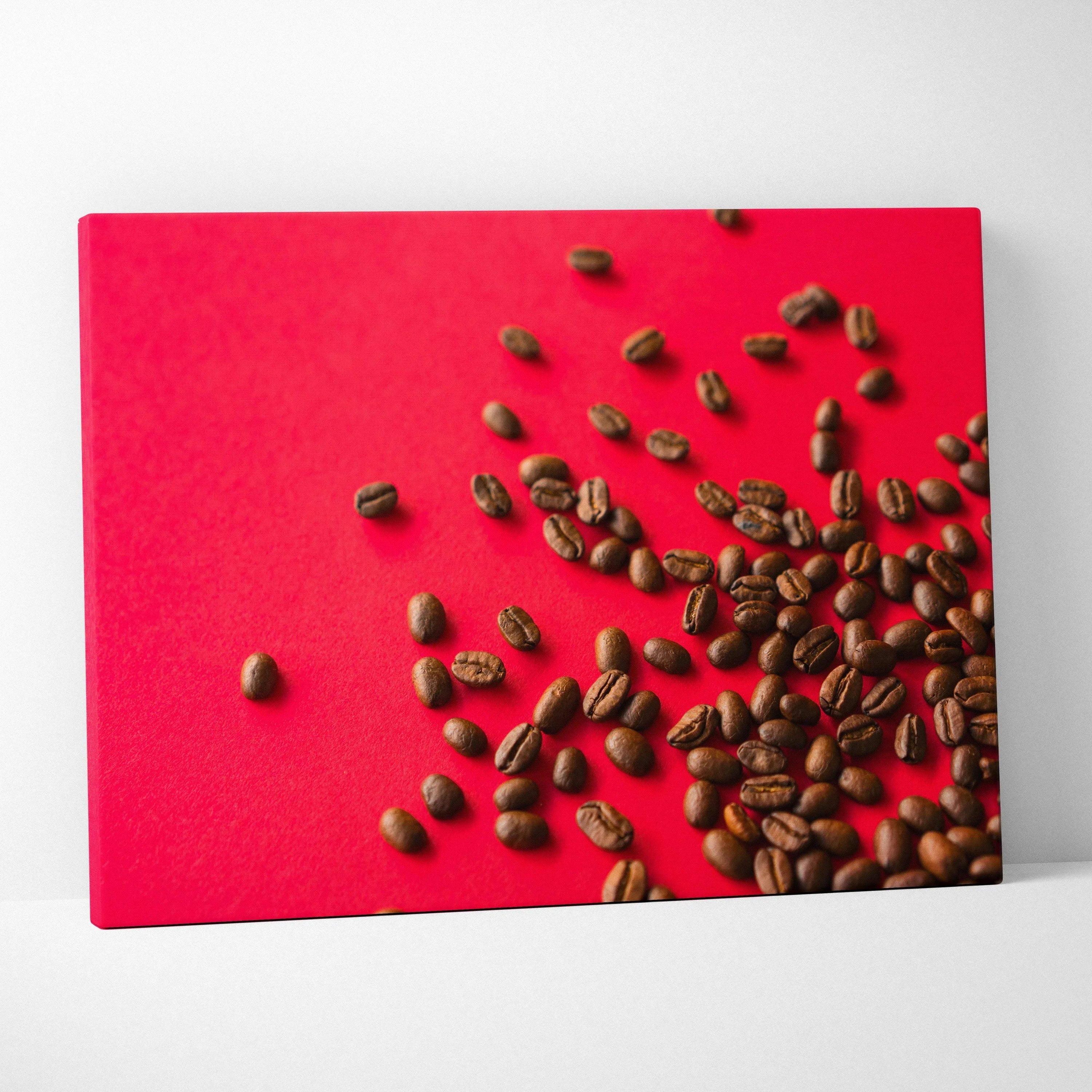 Canvas wall art featuring scattered coffee beans on a vibrant red background for home decor.