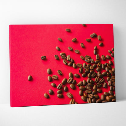 Canvas wall art featuring scattered coffee beans on a vibrant red background for home decor.