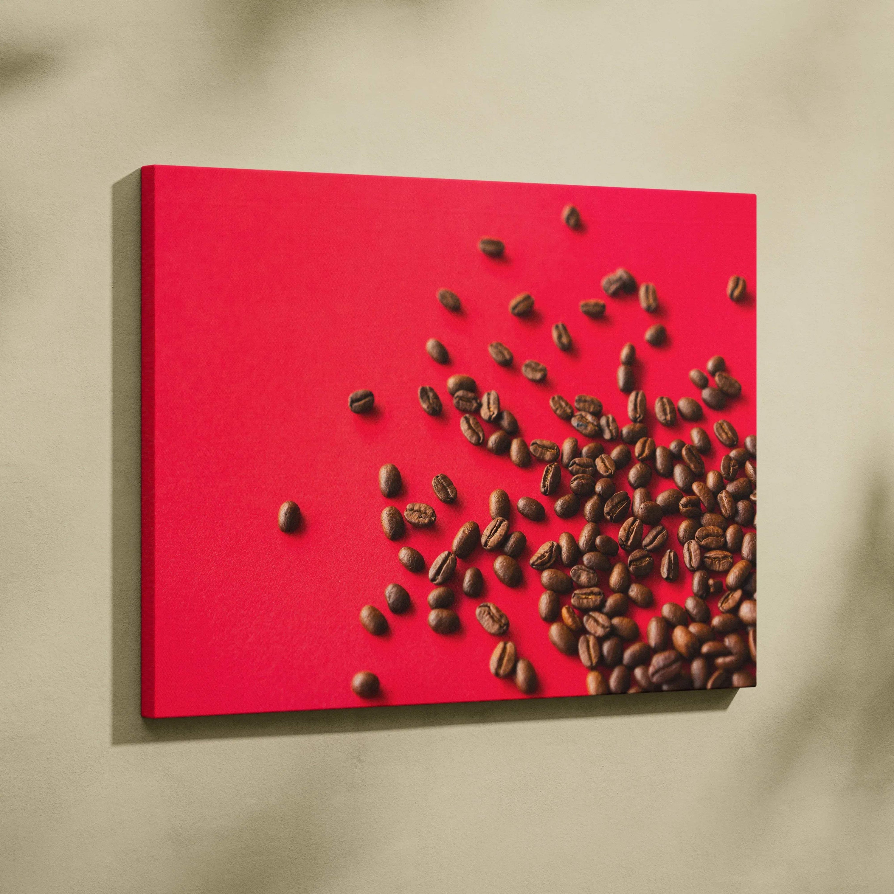 High-resolution canvas wall art featuring scattered dark brown coffee beans on a bold red background.