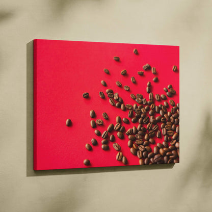 High-resolution canvas wall art featuring scattered dark brown coffee beans on a bold red background.