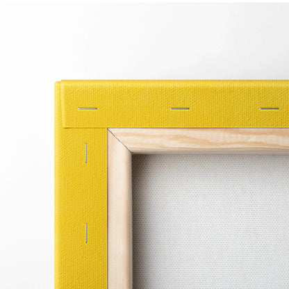 Yellow canvas frame corner with visible wood stretcher bars and metal staples for wall art decor.