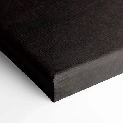 Black wrapped edge of vertical canvas art with textured surface for wall art display.