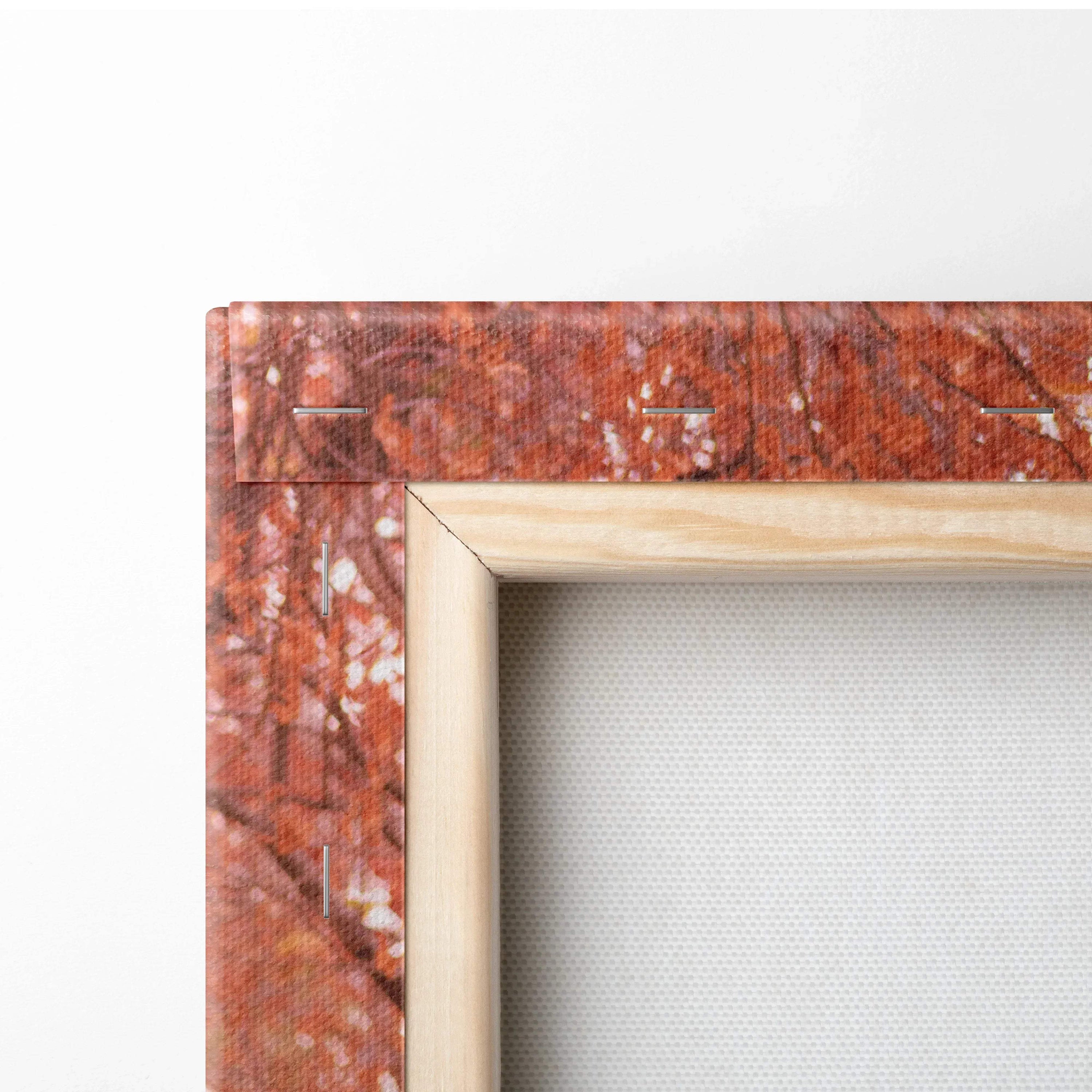Close-up of natural wood-framed canvas art with detailed marbled orange and brown textured wall art edges.