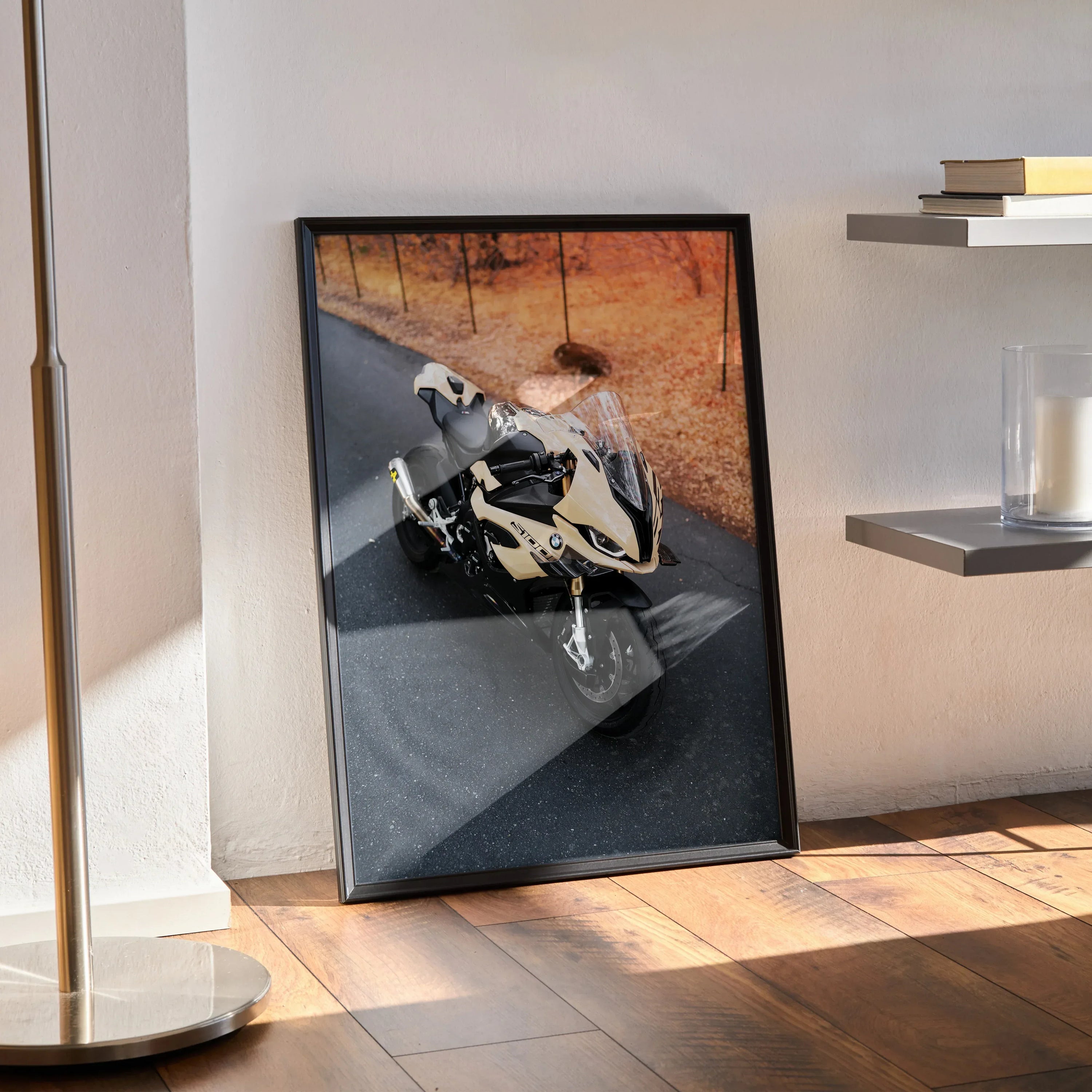 BMW S1000RR motorcycle poster in black frame leaning against wall, stylish wall art with dynamic bike image.