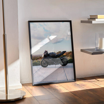 Yamaha R6 motorcycle poster with sleek black frame, leaning against wall in sunlit room, modern wall art.