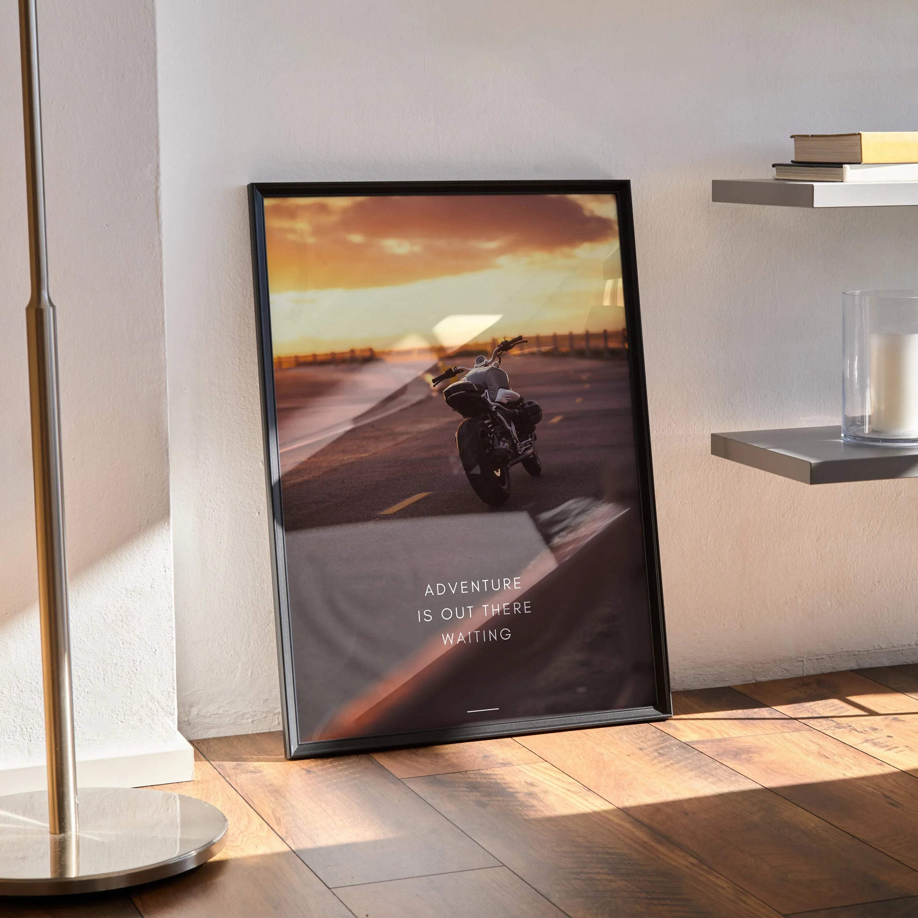 Framed motivational poster wall art with BMW R Nine T motorcycle riding on open road at sunset and text "Adventure is out.