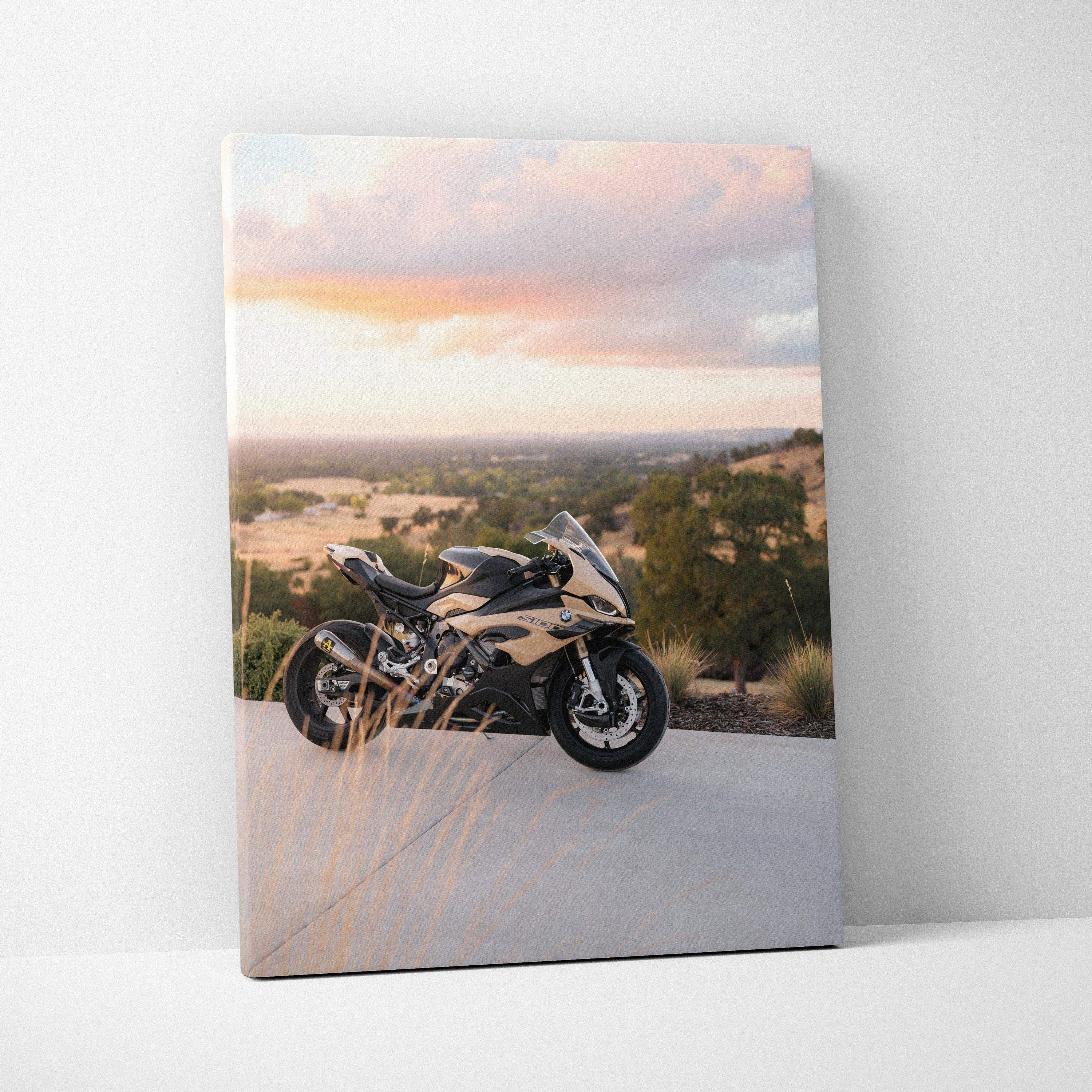 BMW S1000RR motorcycle parked outdoors at sunset on canvas wall art with warm sky background.