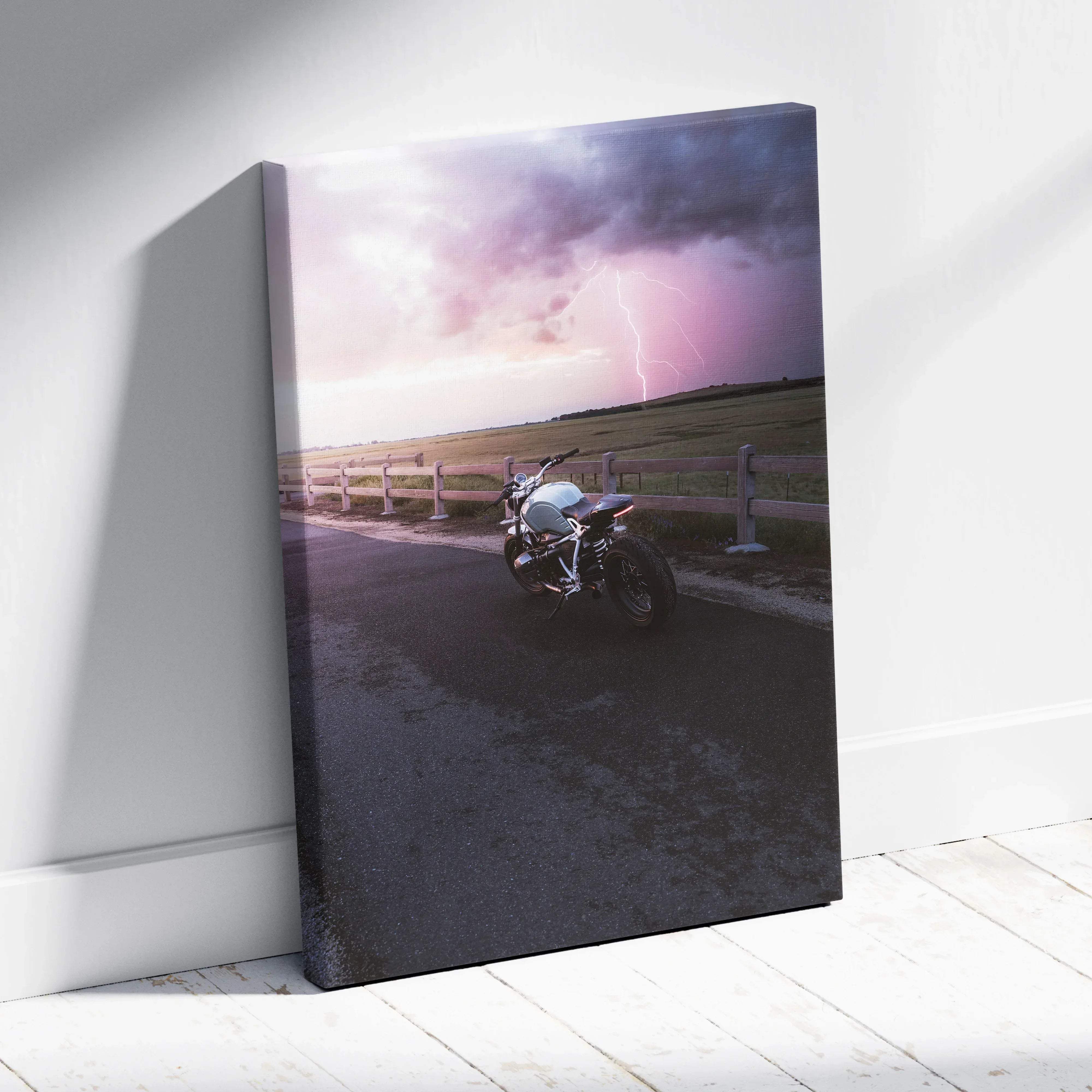 Canvas wall art featuring a silver bmw inspired r nine t motorcycle under a stormy purple and gray sky with lightning