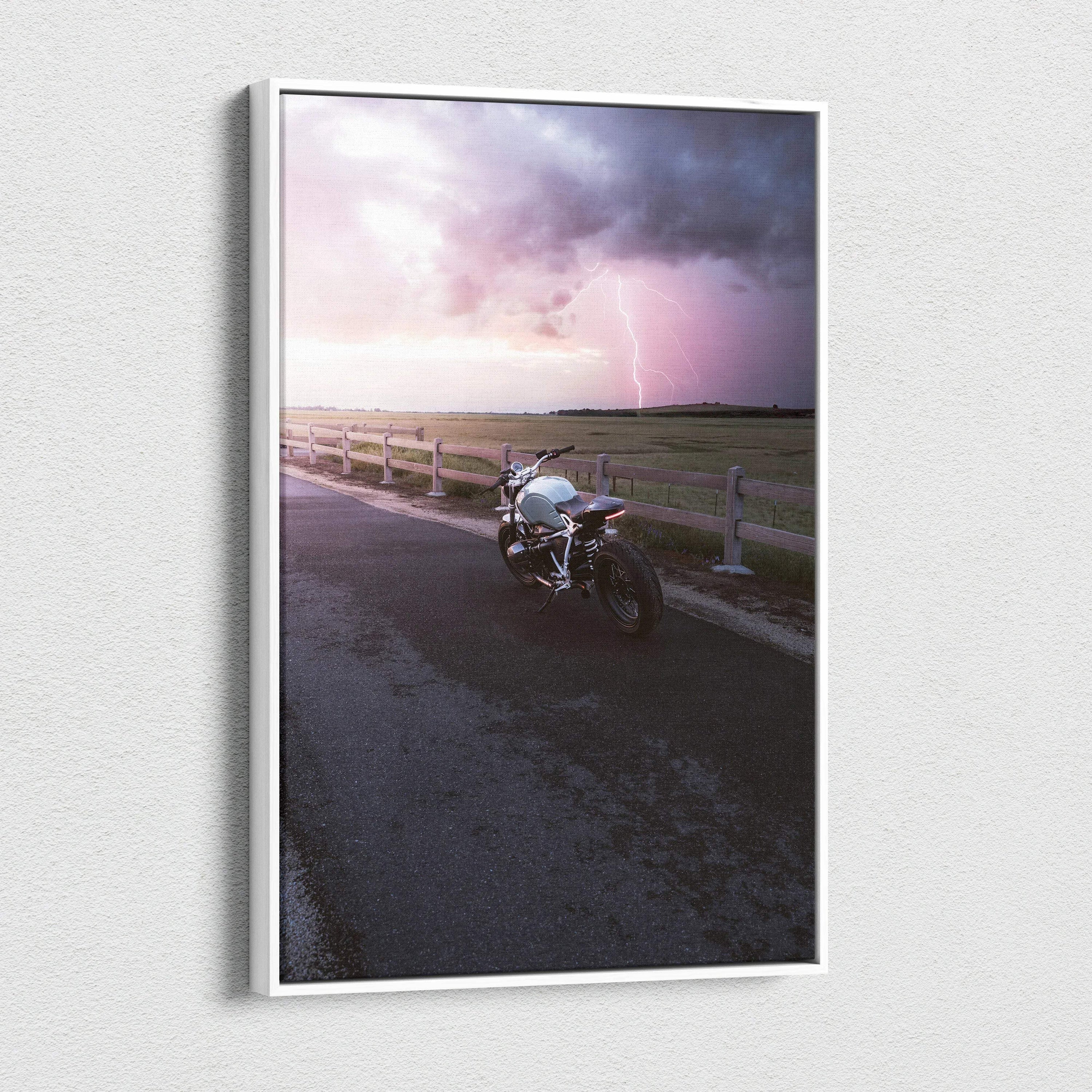 BMW R Nine T motorcycle on road at sunset with dramatic sky canvas wall art.