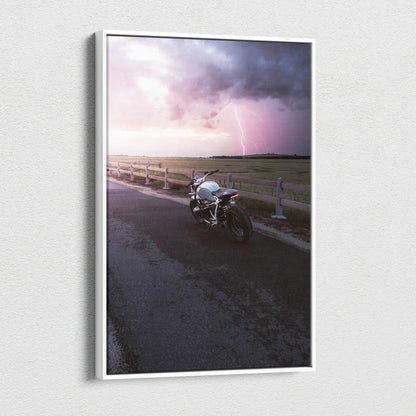 BMW R Nine T motorcycle on road at sunset with dramatic sky canvas wall art.