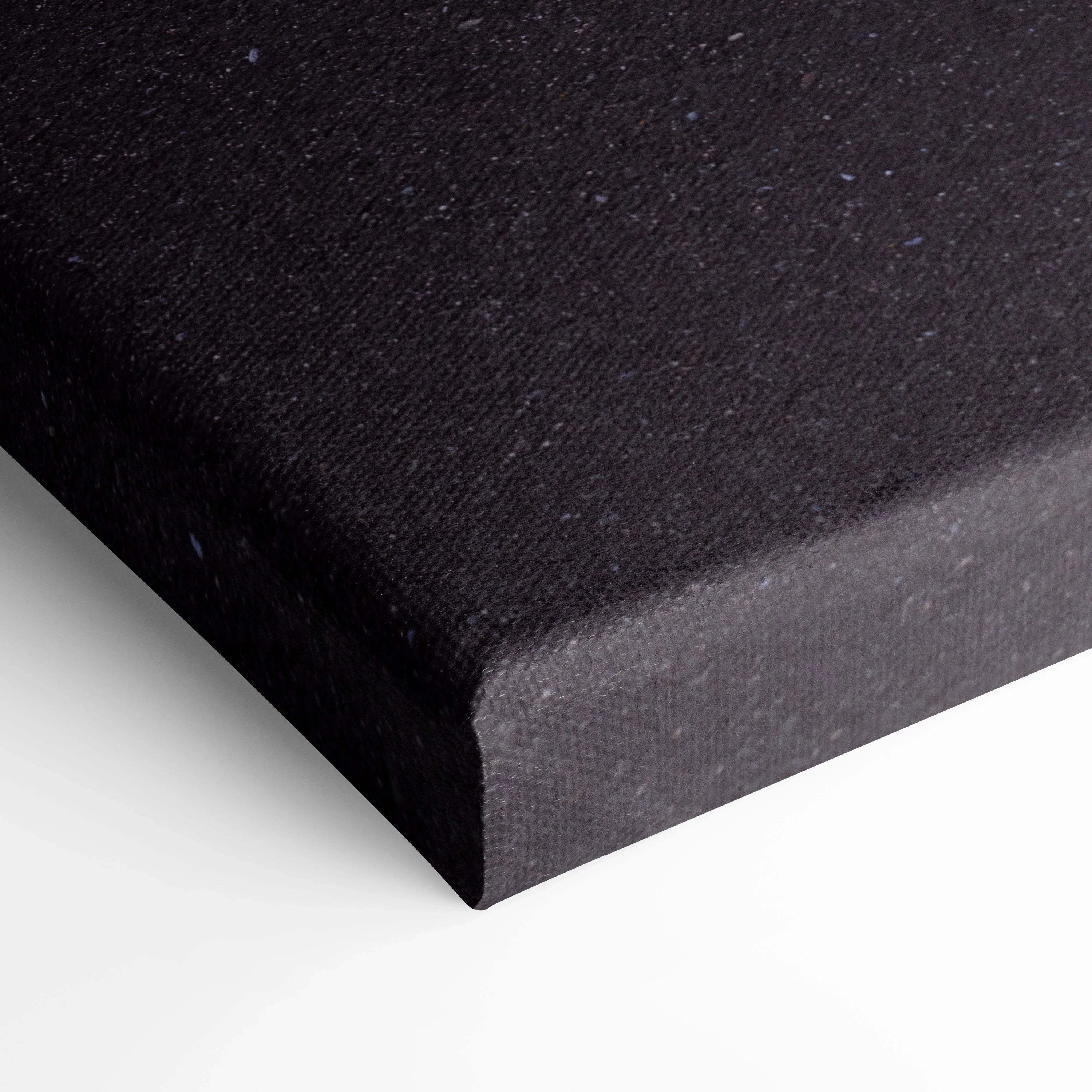 Black stretched canvas corner with textured fabric, high-quality wall art material.