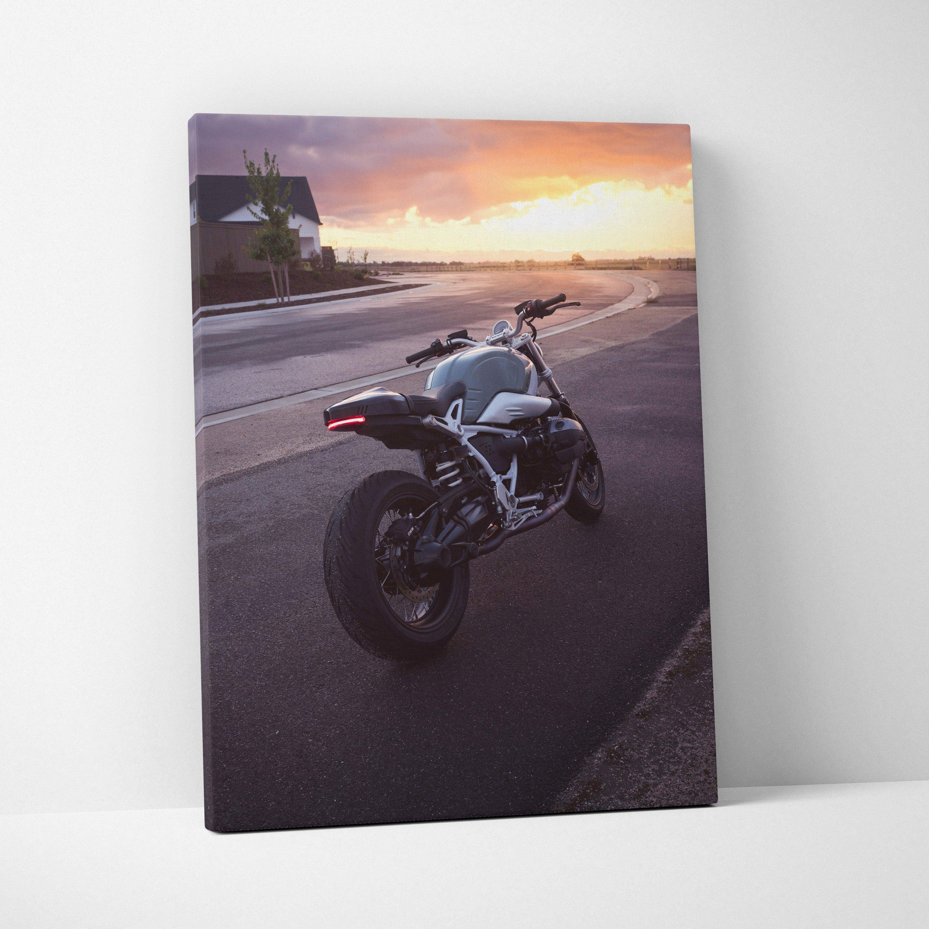 BMW R Nine T motorcycle at sunset on canvas wall art with vibrant orange sky background.