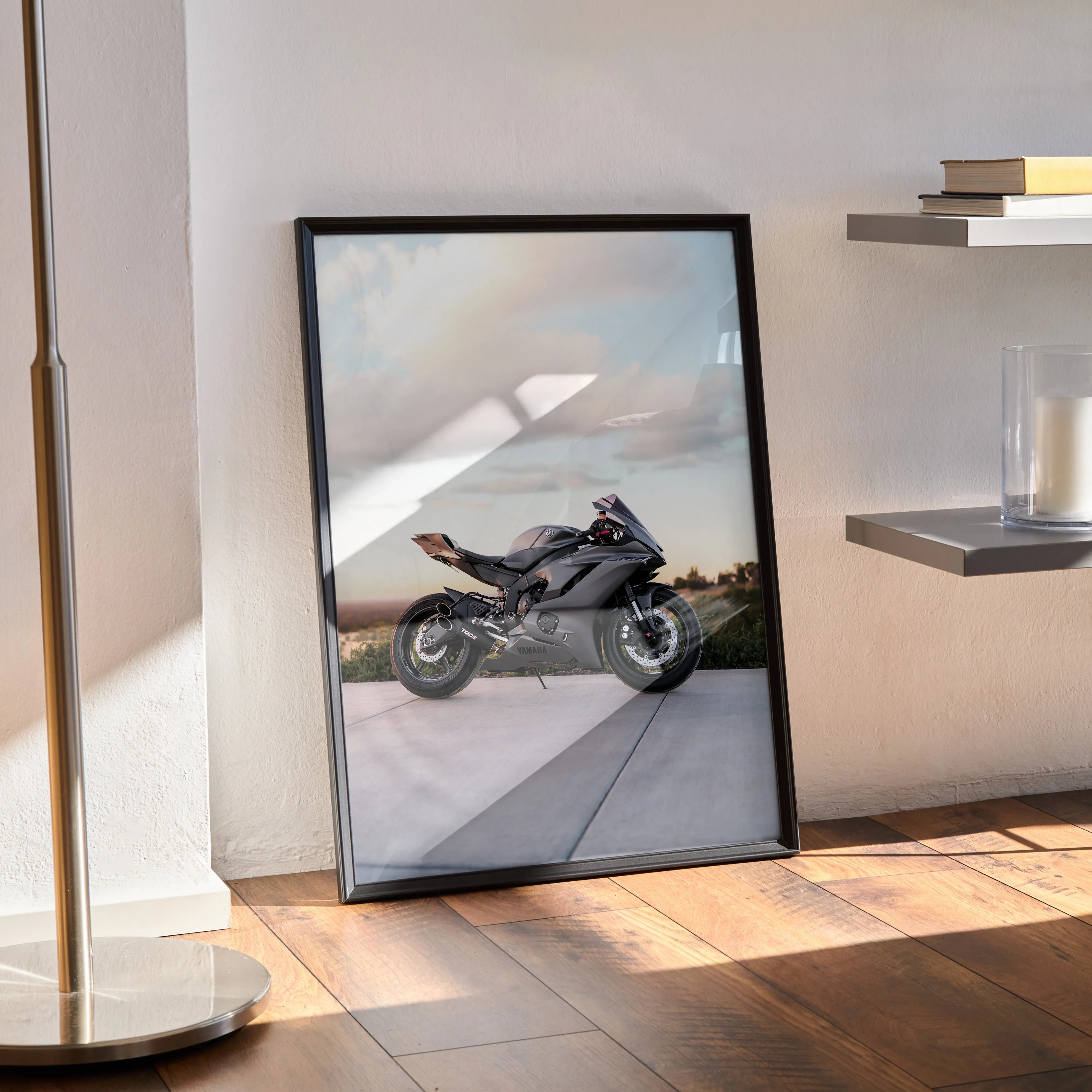 Yamaha R6 motorcycle poster in a black frame leaning against a wall on wooden floor wall art.