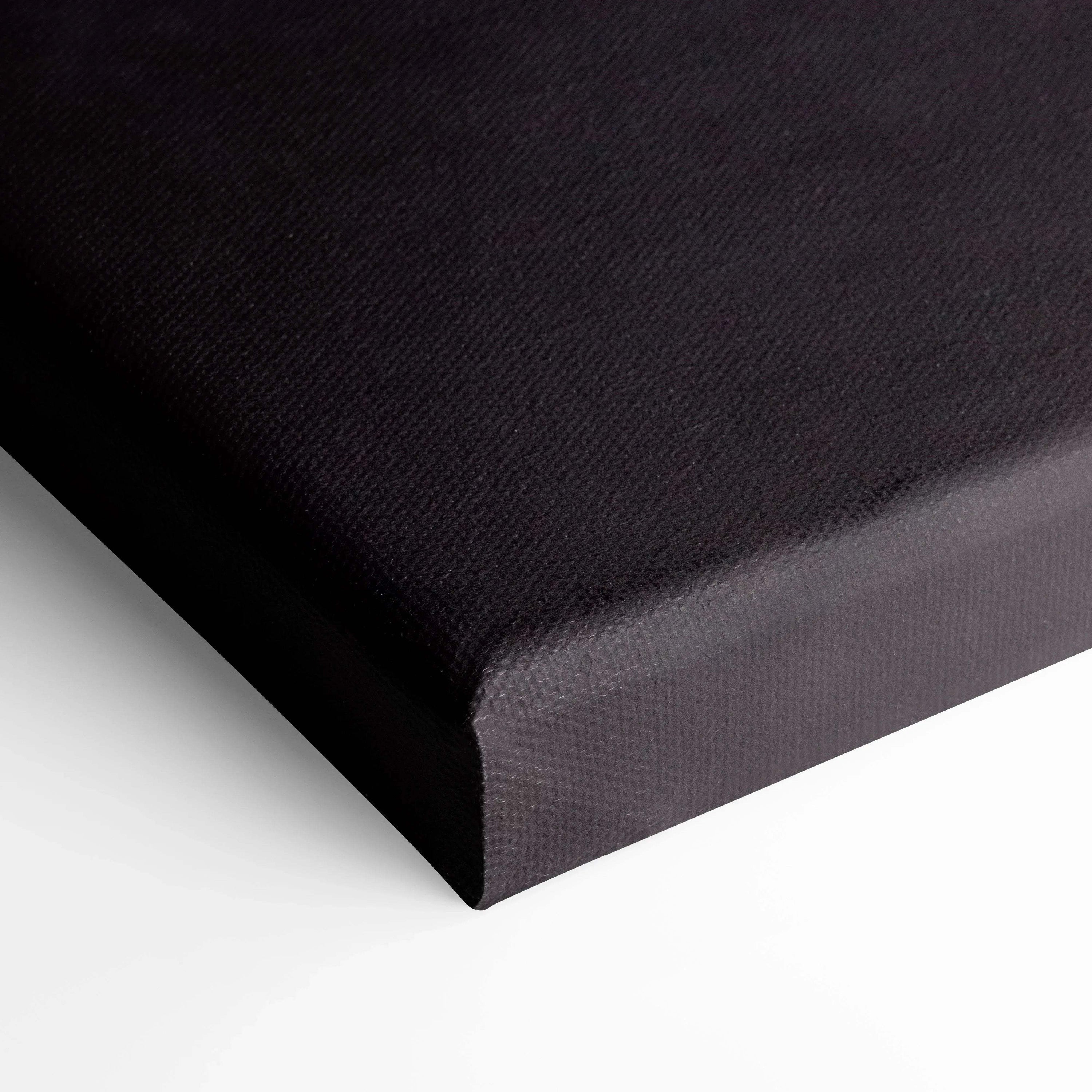 Close-up of black textured canvas corner stretched for vertical wall art display.