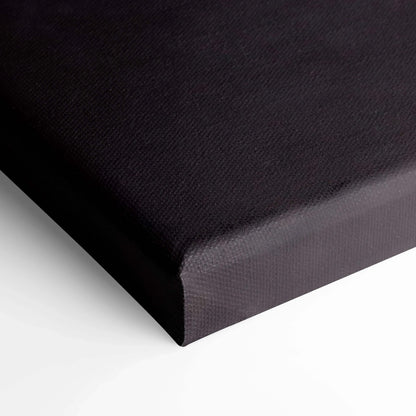 Close-up of black textured canvas corner stretched for vertical wall art display.