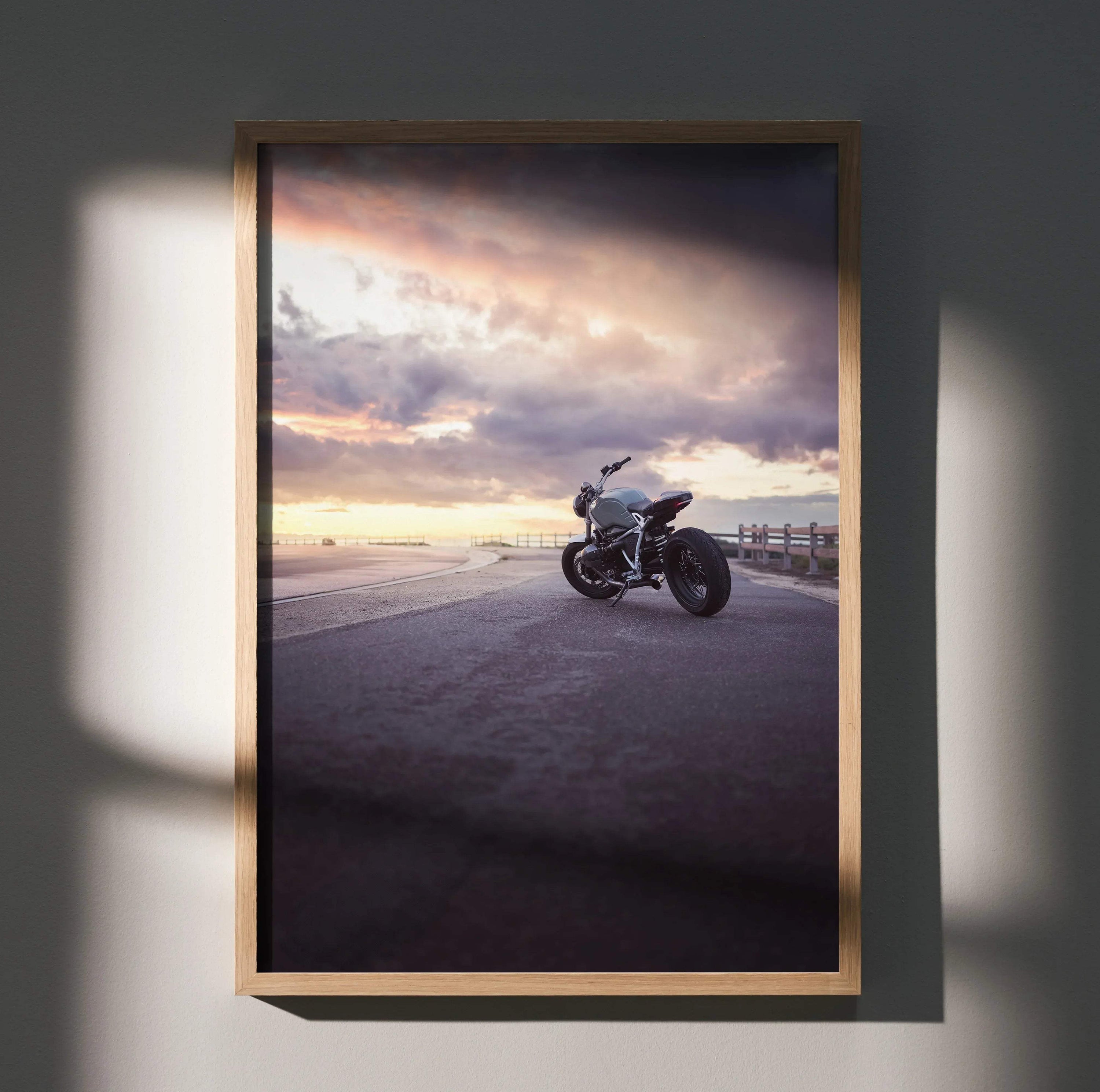 BMW R Nine T motorcycle parked at sunset with dramatic sky, framed poster wall art.