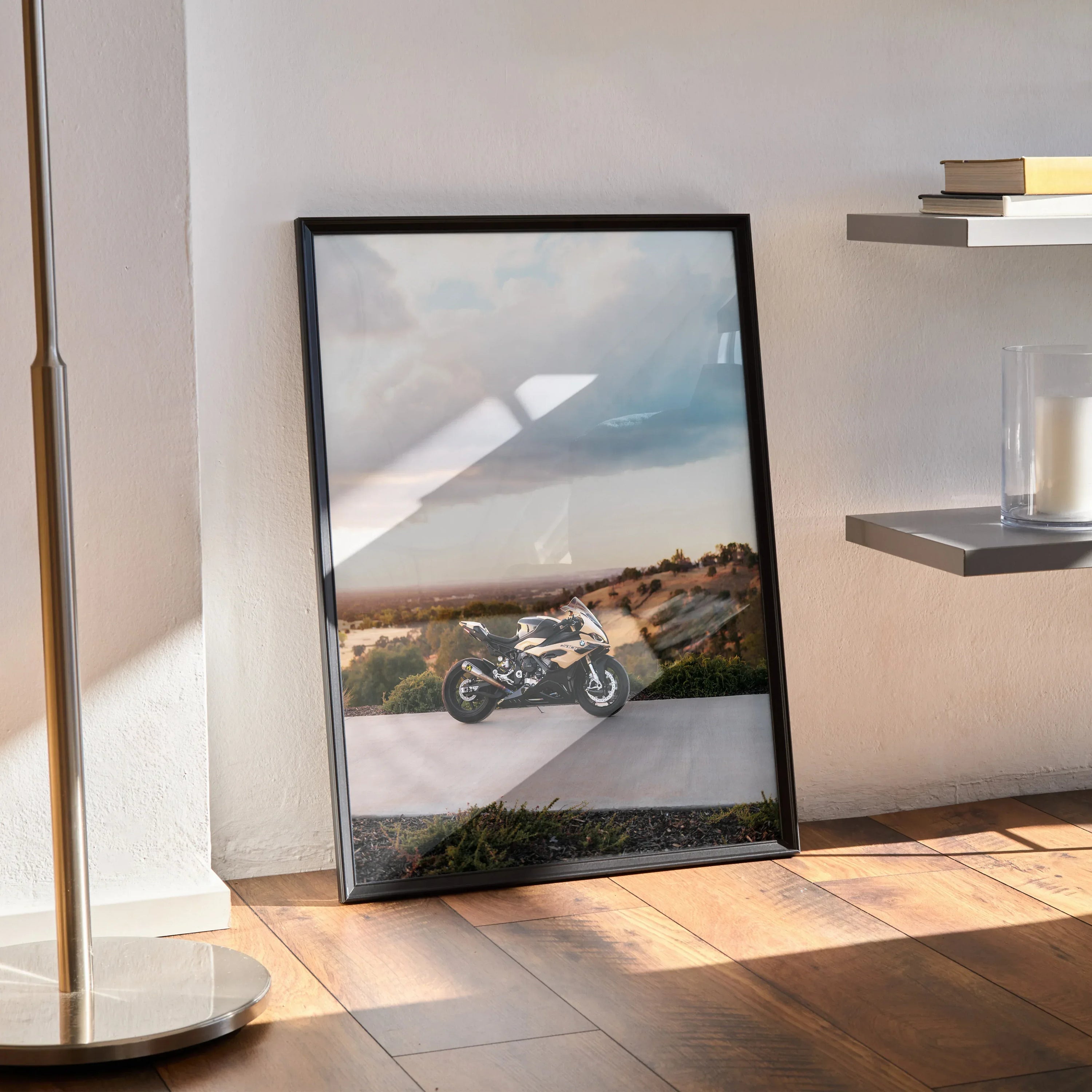 BMW S1000RR motorcycle poster framed as modern wall art leaning against wall on wood floor.