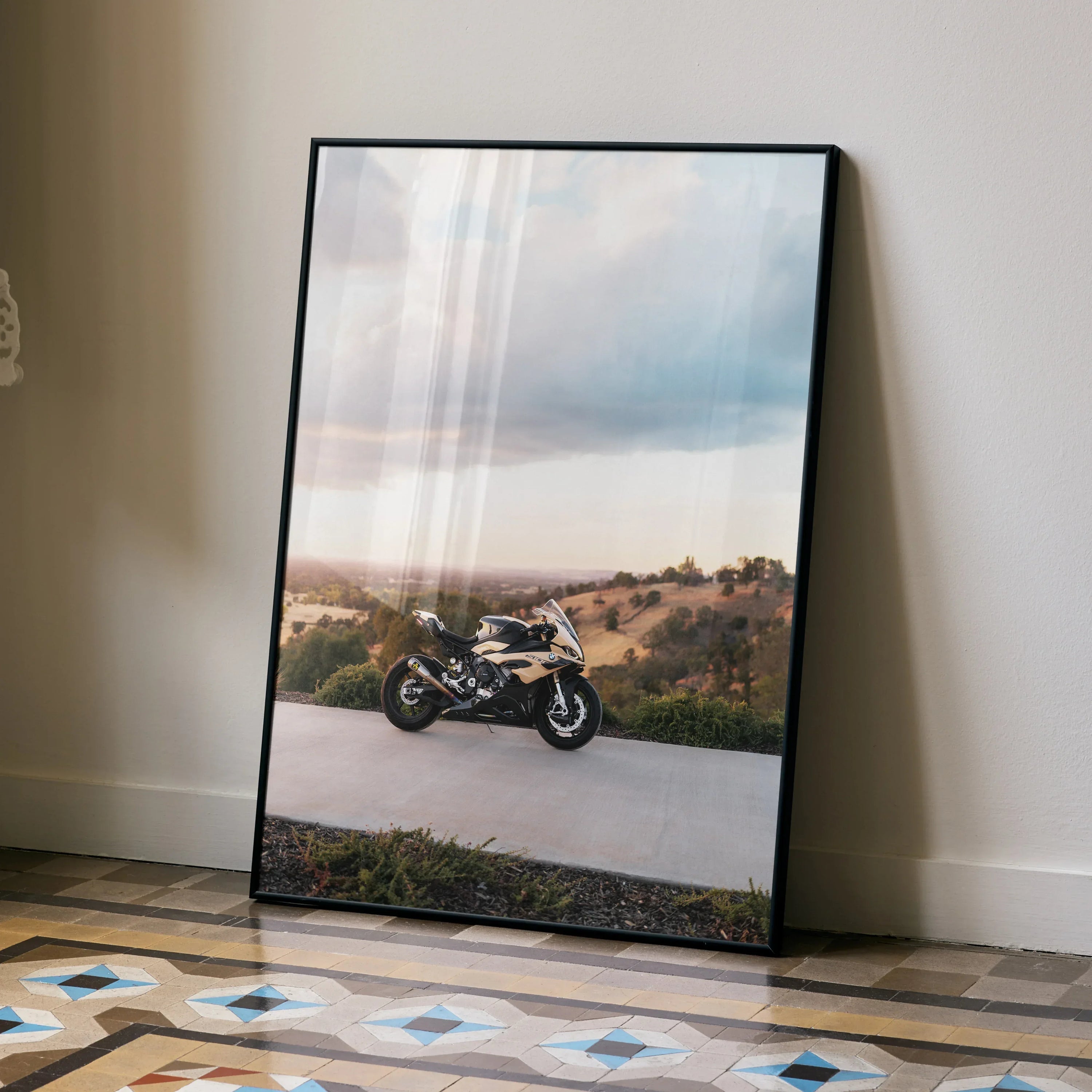 BMW S1000RR motorcycle poster leaning against wall with scenic background, wall art for motorcycle fans.