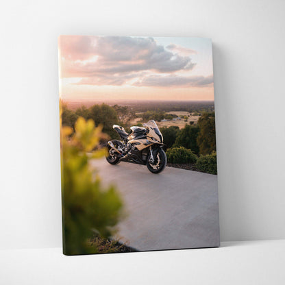 BMW S1000RR motorcycle on pavement at sunset canvas wall art with scenic background.