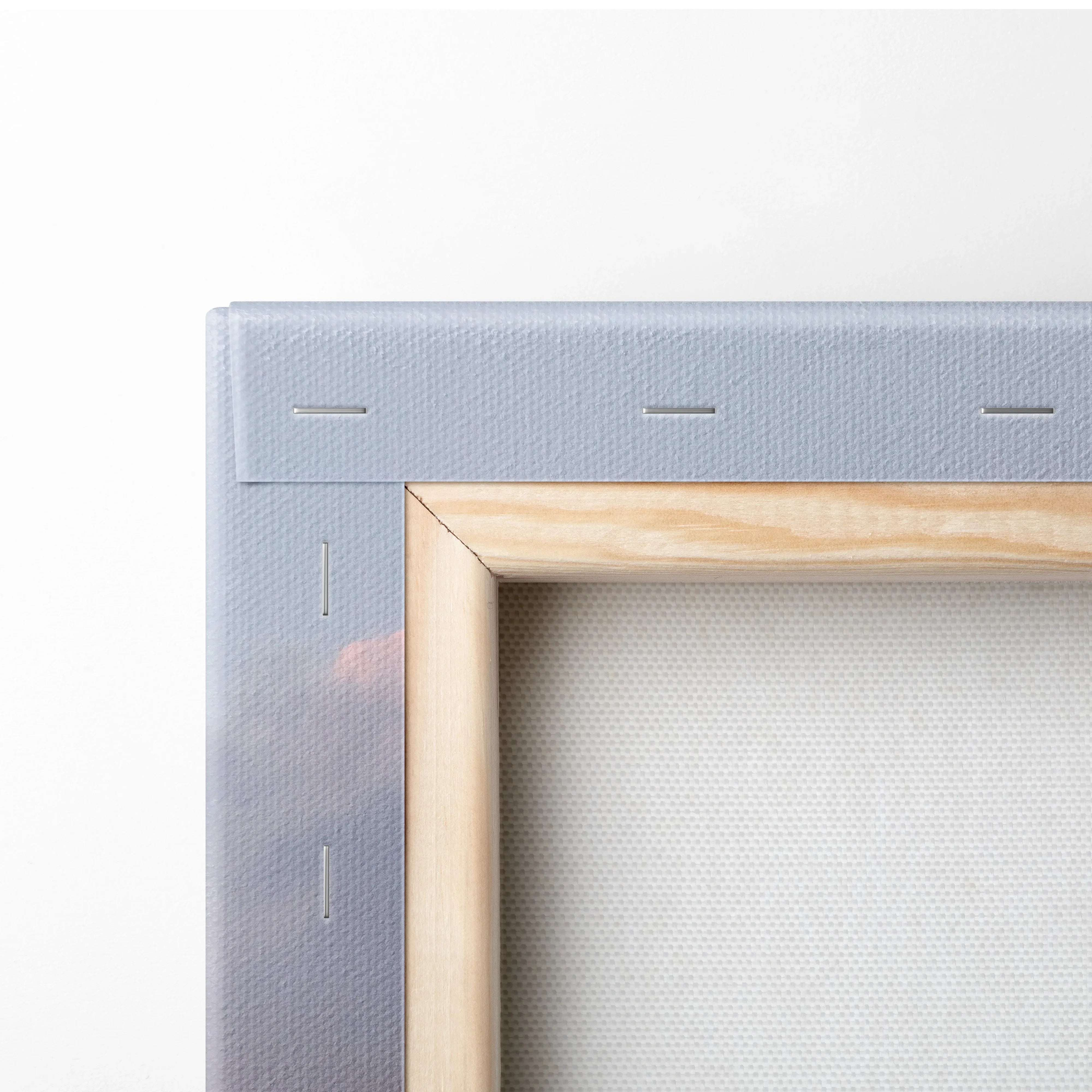 Close-up of wooden frame and stapled canvas edge for vertical Yamaha R6 motorcycle wall art canvas print.