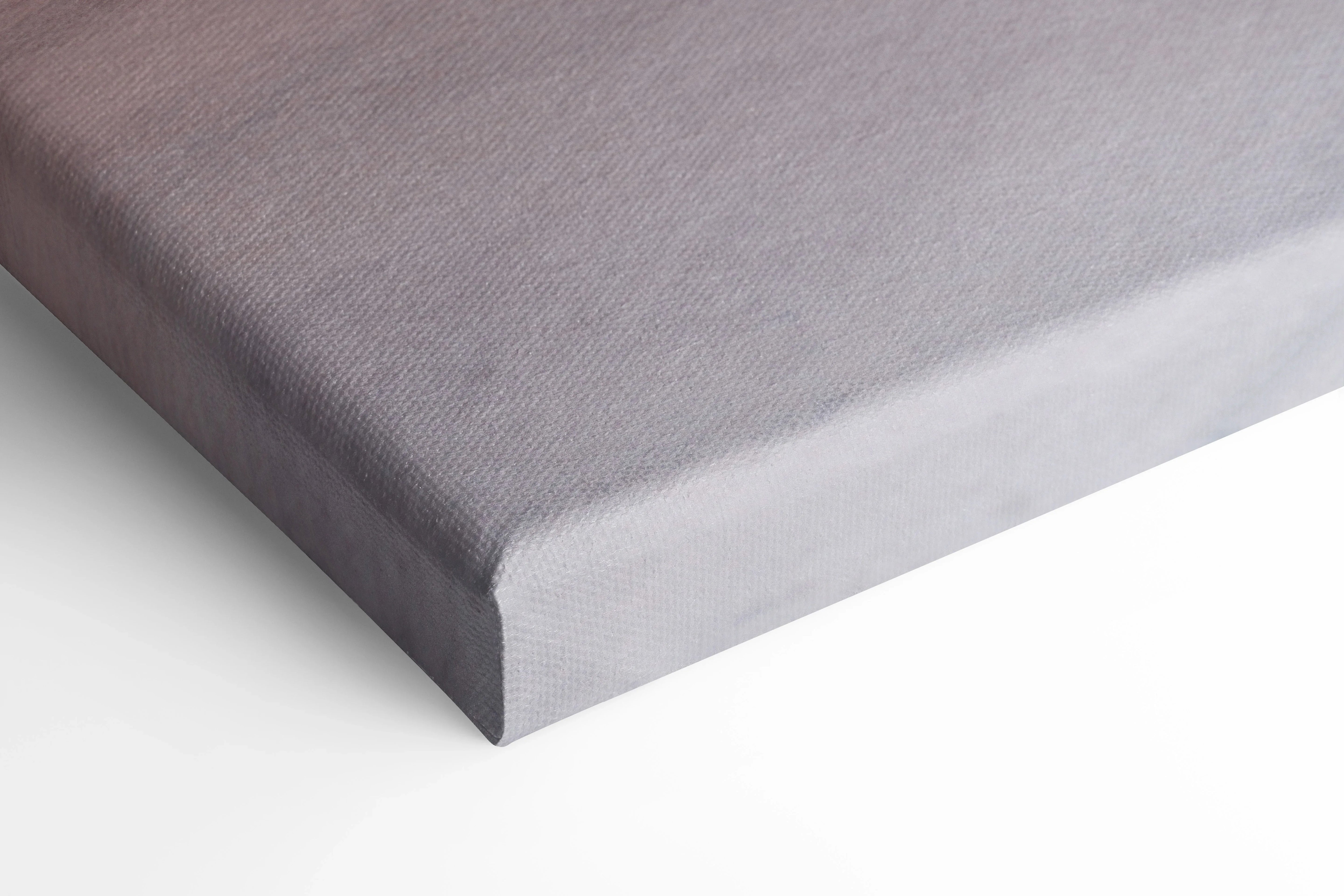 Close-up of corner edge on gray canvas wall art with textured surface and black stretcher bars.