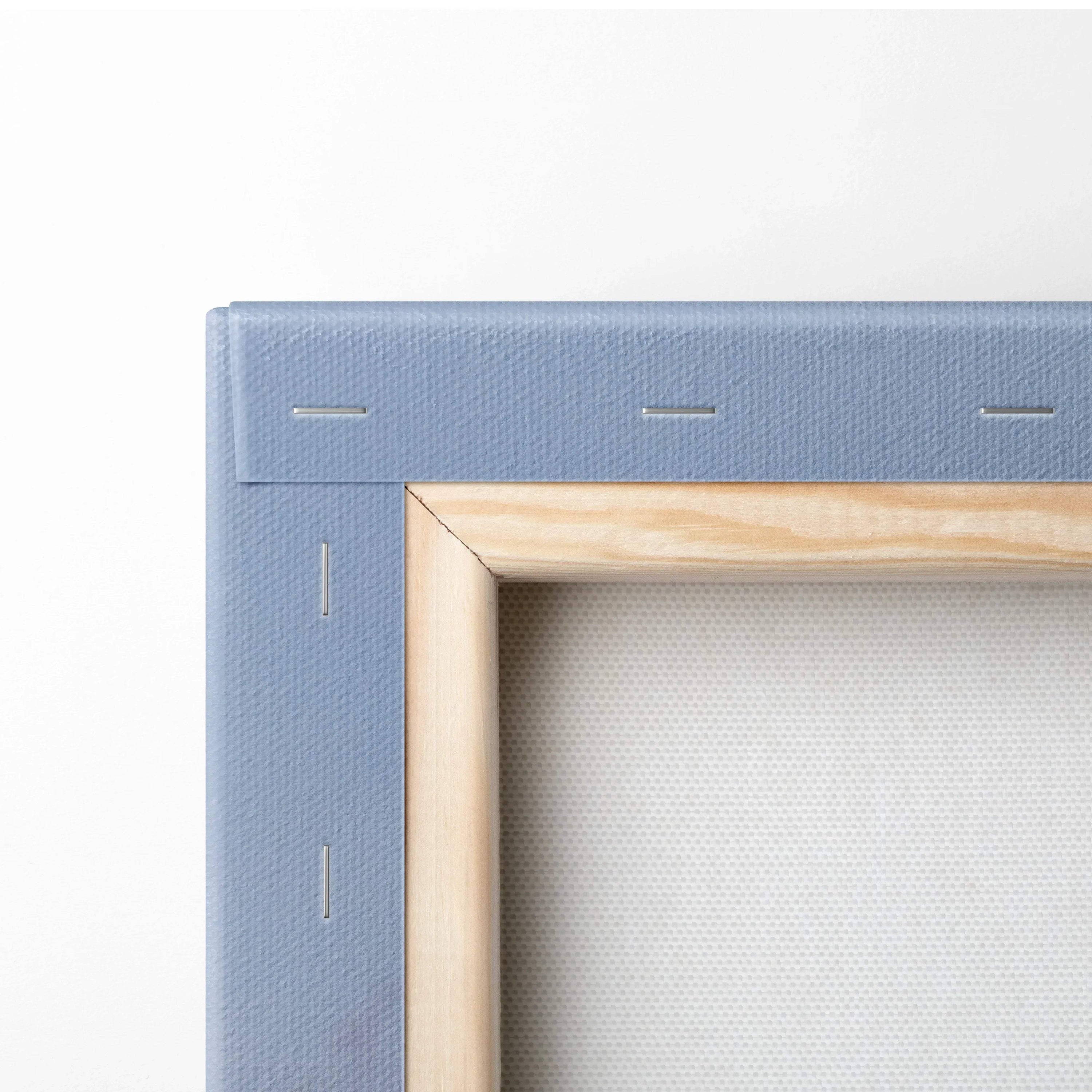 Edge detail of stretched canvas with light wood frame and blue-painted stretcher bars for wall art canvas print.