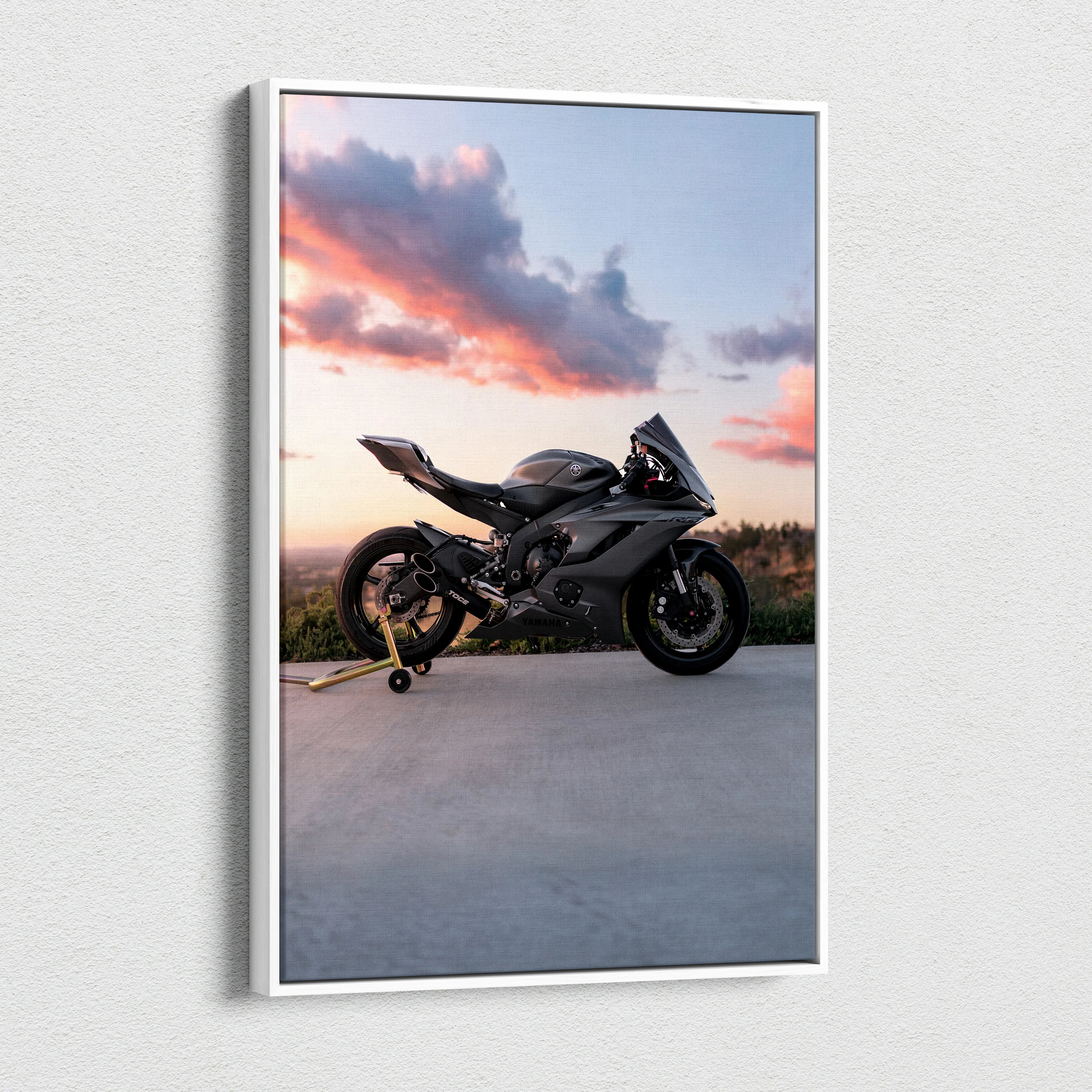 Vertical canvas wall art featuring a black Yamaha R6 motorcycle against a sunset sky.