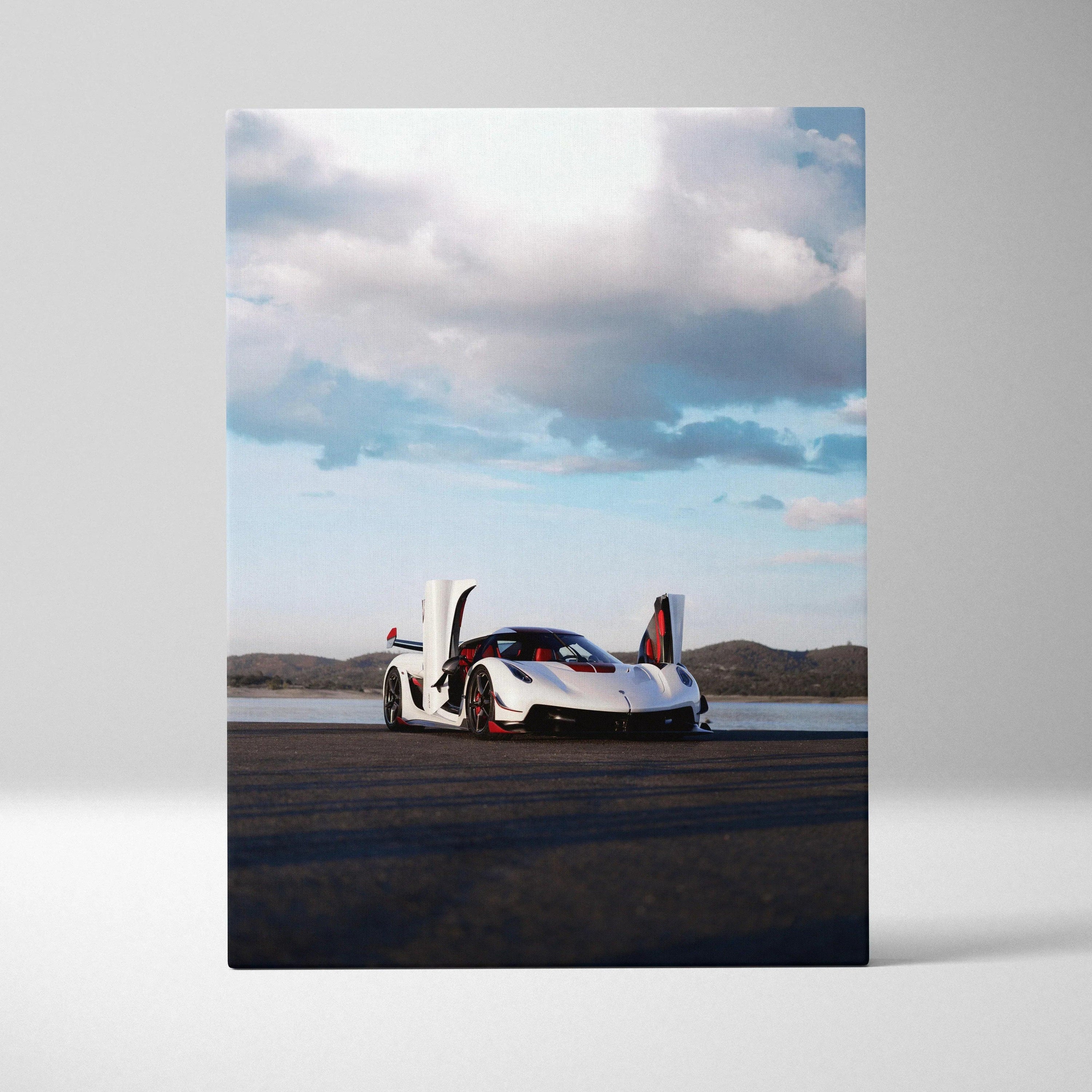 Vertical canvas art of white Koenigsegg Jesko with scissor doors open on open road under cloudy sky wall art.