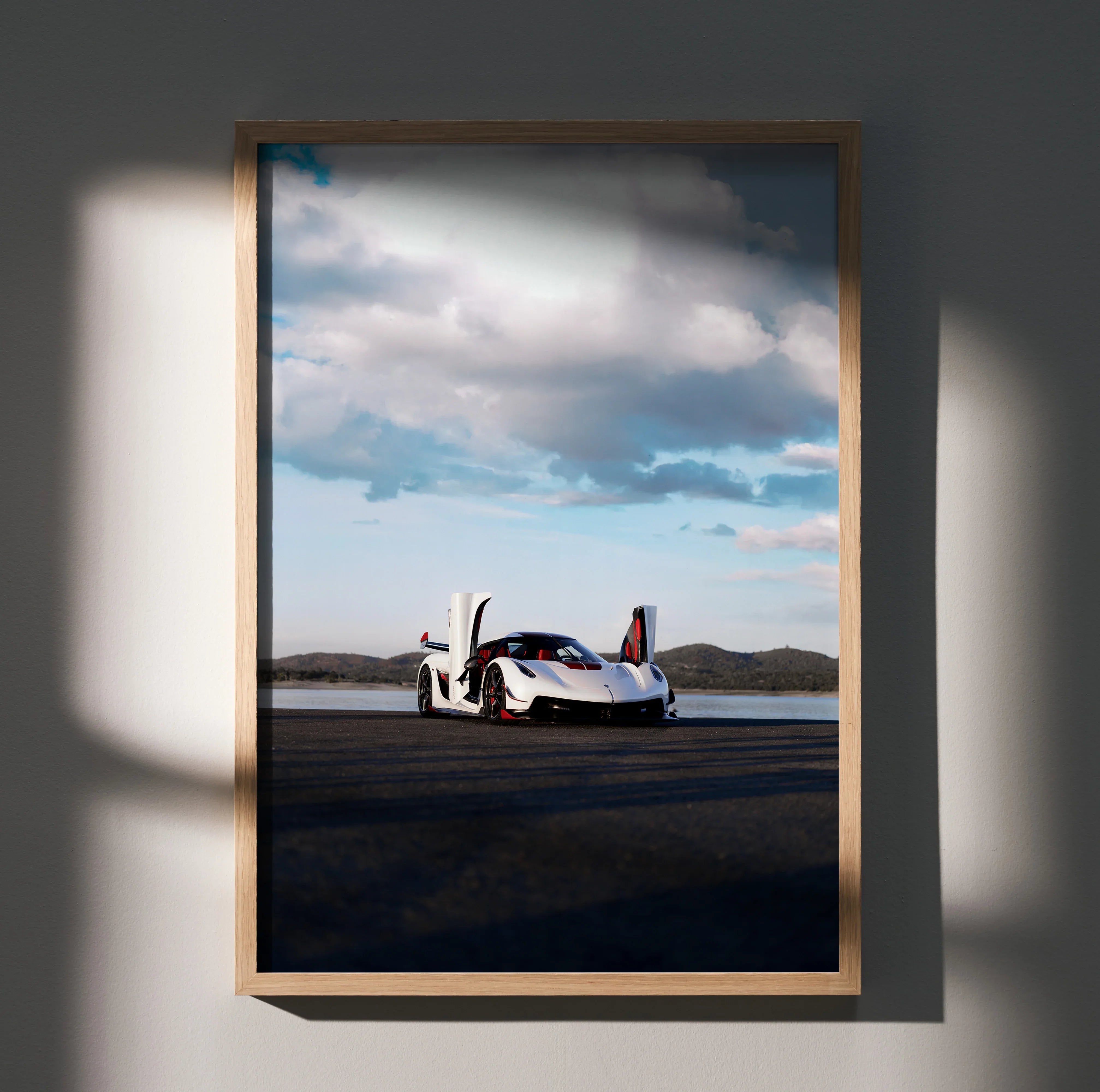 Koenigsegg Jesko white hypercar poster wall art with open doors and cloudy sky background.
