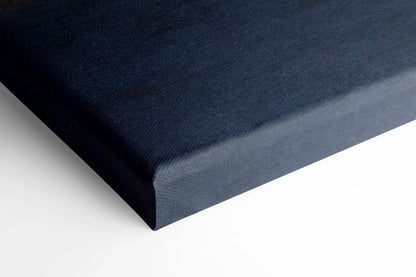 Close-up of navy blue canvas edge on museum-quality wall art print with smooth texture.