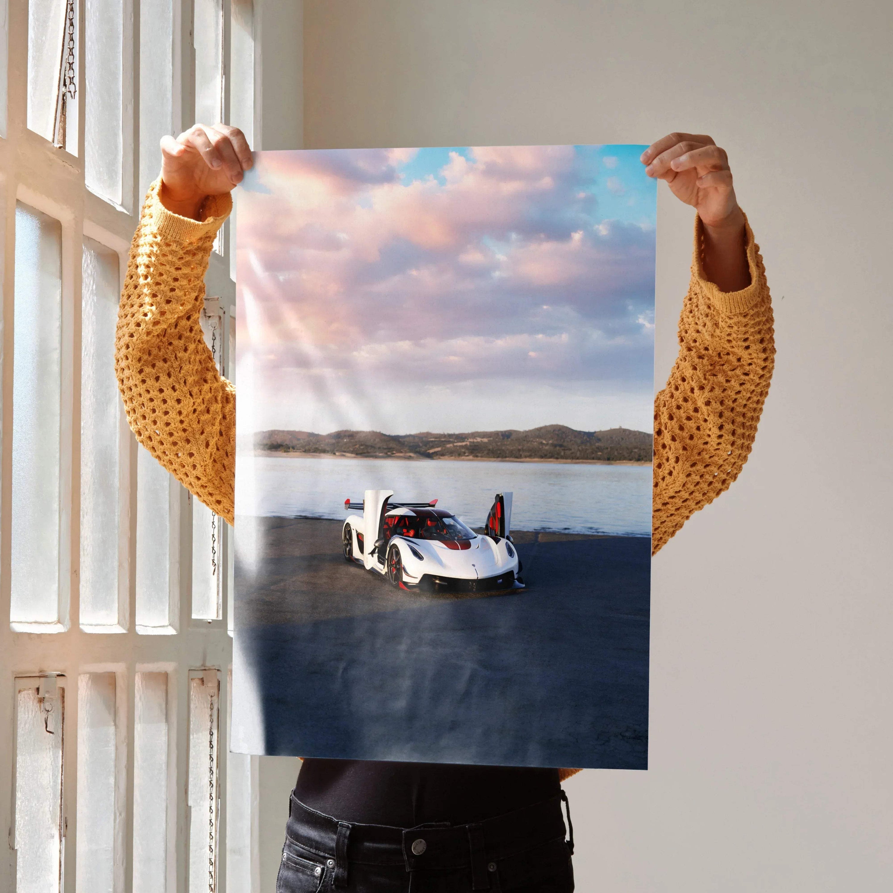 Koenigsegg Jesko poster wall art featuring sleek white sports car on open landscape under cloudy sky.