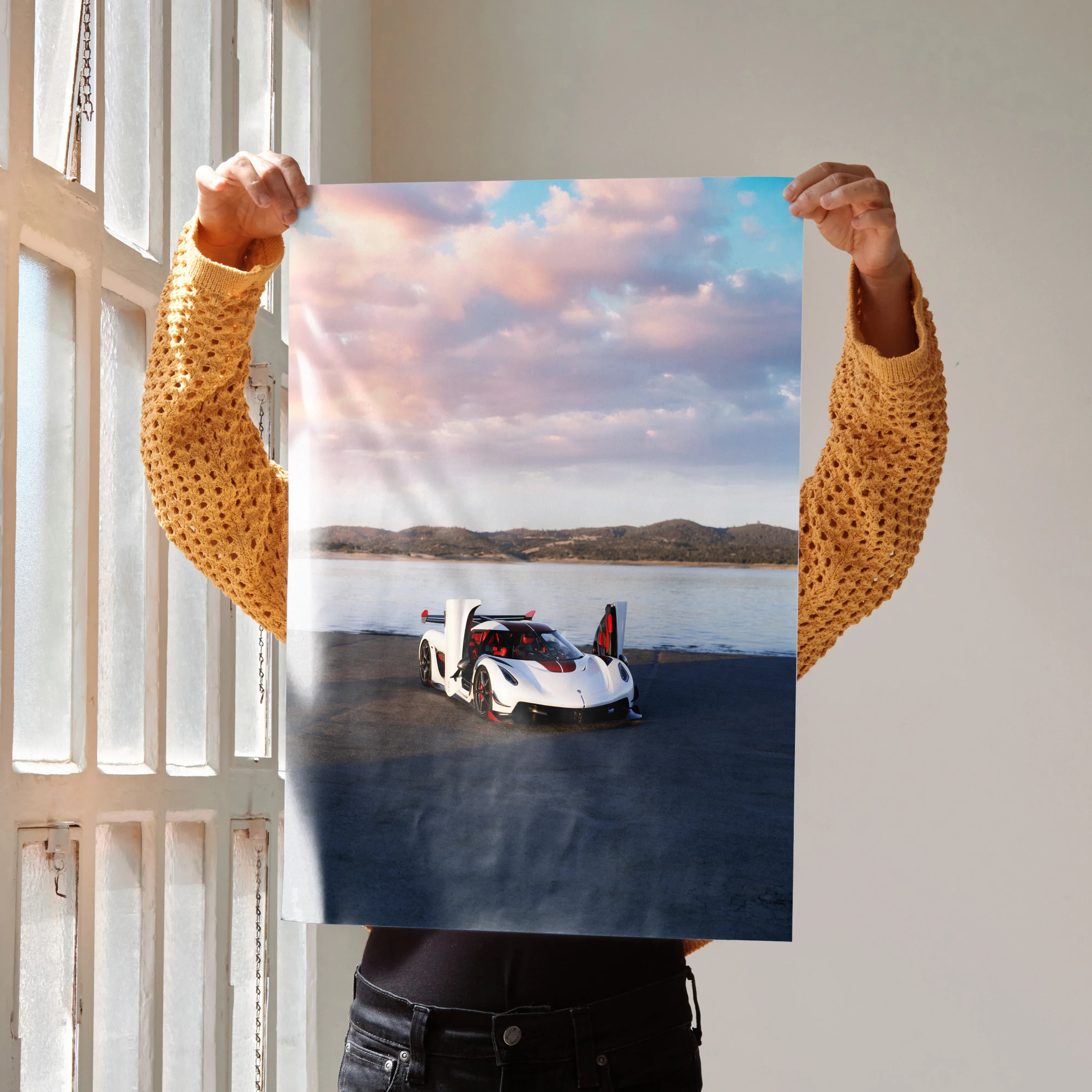 Koenigsegg Jesko poster wall art featuring sleek white sports car on open landscape under cloudy sky.