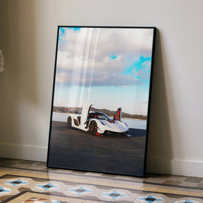 Koenigsegg Jesko white sports car against cloudy sky poster wall art in black frame.