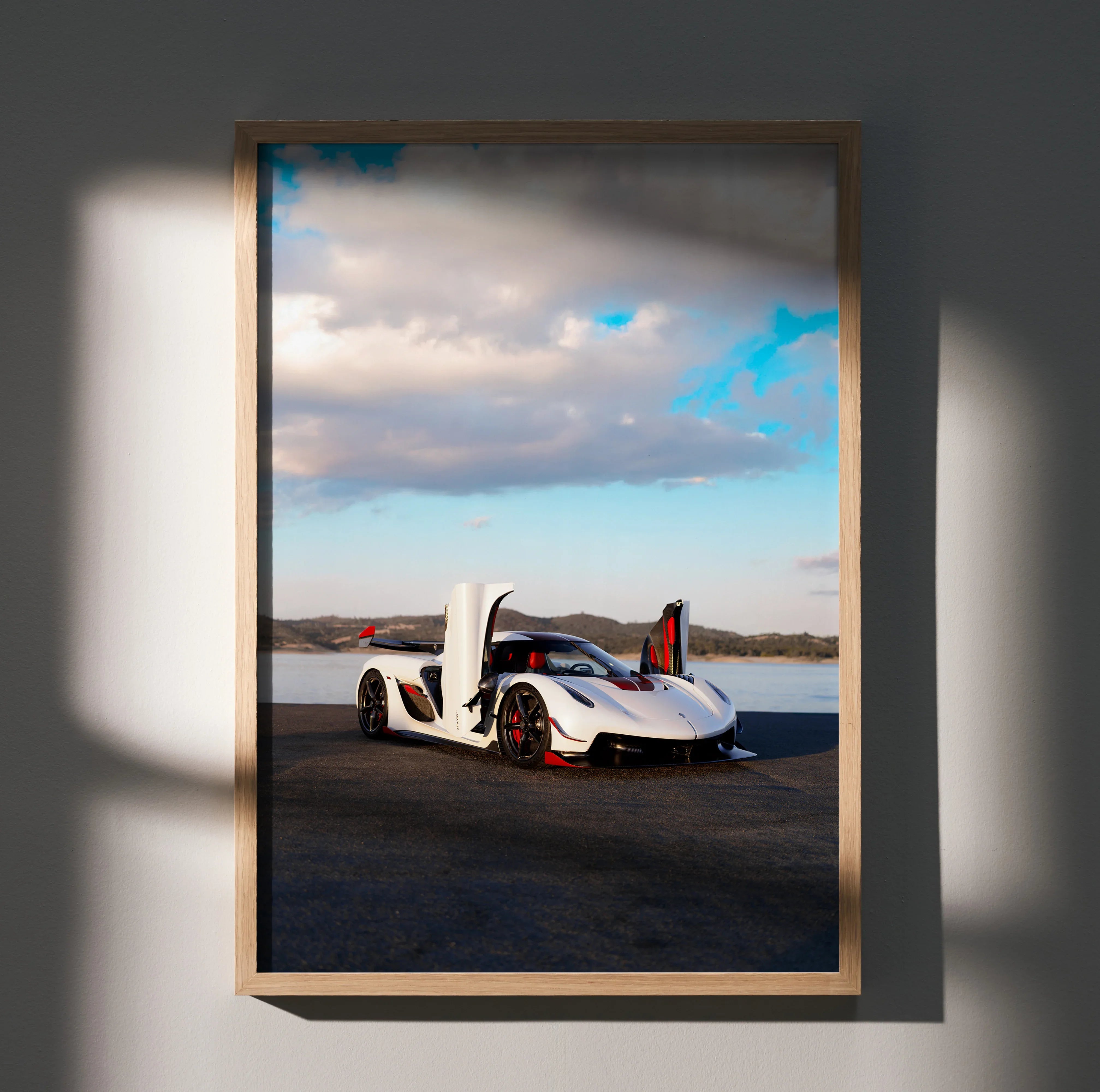 Koenigsegg Jesko sports car poster with white body and butterfly doors open, wall art in natural light.