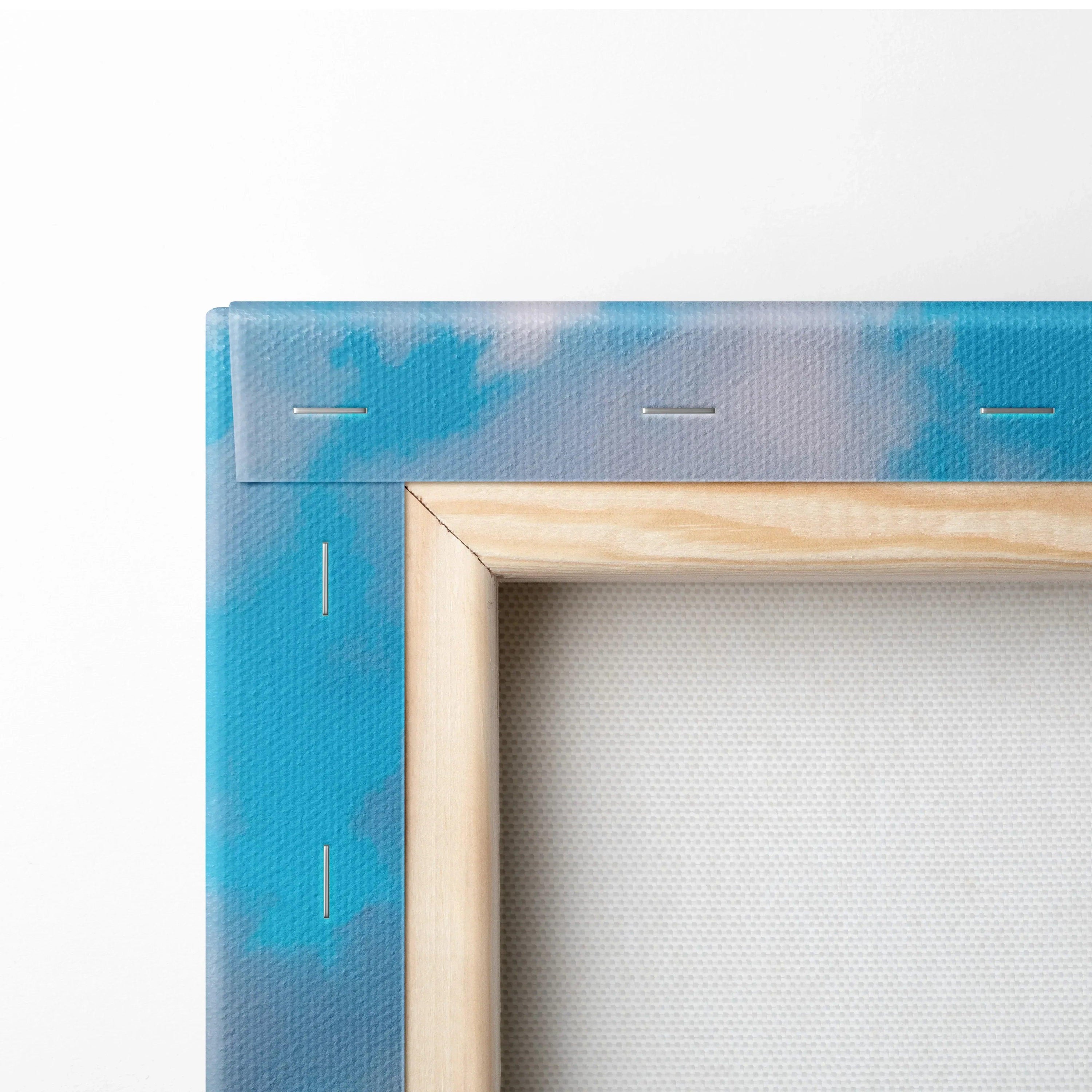 Close-up of wooden frame and stretched canvas corner with blue sky and cloud print wall art.