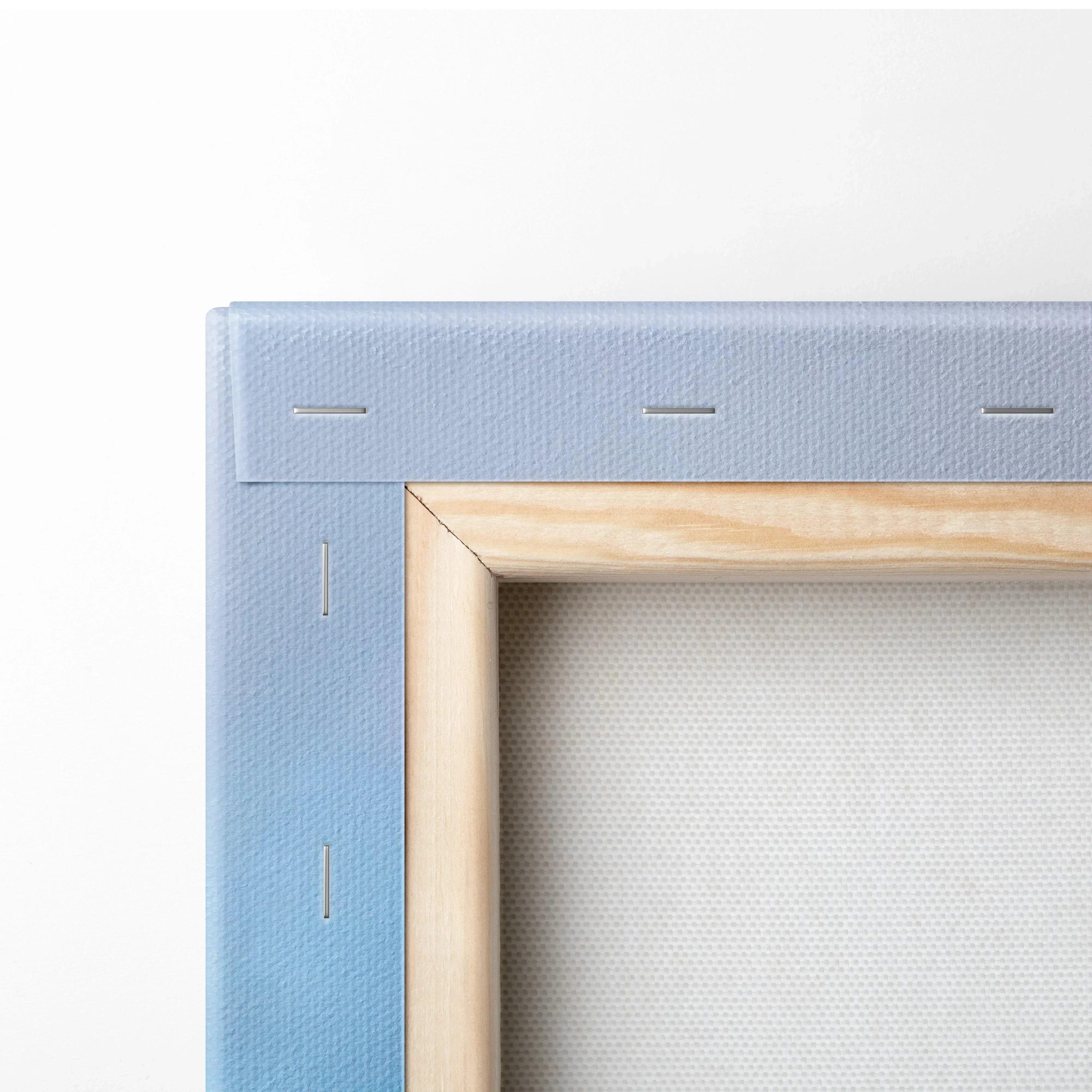 Close-up of blue gradient canvas wall art corner with wooden stretcher bars and metal staples.